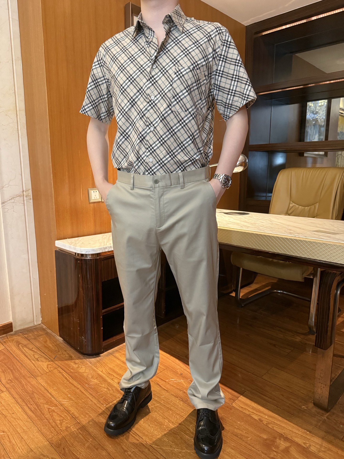 NO:855827,Burberry - Classic plaid men's short-sleeved shirt. The fabric is mostly made of high-count cotton poplin. It has a fine texture, a silky feel, is skin-friendly and breathable, and has a good drape feeling. It is not stuffy and sweaty when worn in summer, and it is also stiff and not easy to wrinkle. The technical plaid is precisely cut in position, and the collar is lining to increase the stiffness. The buttons are mostly customized by the brand, and the details highlight the high-end texture. Suitable outfits  In the picture, it is paired with a plaid shirt + light khaki casual trousers + black brogue leather shoes to create a business casual style, suitable for commuting, light business, daily gatherings and other scenes. The expanded combination can be paired with jeans and casual shorts, suitable for casual outings; it can also be layered with a white T to create an American retro style, which can be worn multiple times. S-219860909博柏利-经典格纹男士短袖衬衫 面料多采用高支棉府绸,织纹细腻、手感丝滑,亲肤透气、垂坠感好,夏季穿着不闷汗,同时兼具挺括度,不易起皱. 工艺格纹精准对位剪裁,领部做衬提升挺括度,纽扣多采用品牌定制款,细节彰显高端质感. 穿搭适配 图中搭配格纹衬衫+浅卡其色休闲西裤+黑色布洛克皮鞋,打造商务休闲风,适配通勤、轻商务、日常聚会等场景. 拓展搭配可搭配牛仔裤、休闲短裤,适配休闲出街；也可内搭白T做叠穿,打造美式复古风,一衣多穿. S-2XL码（模特身高180体重145穿L码）,,shorts,jeans,shirts,T-shirt,,Men's clothing