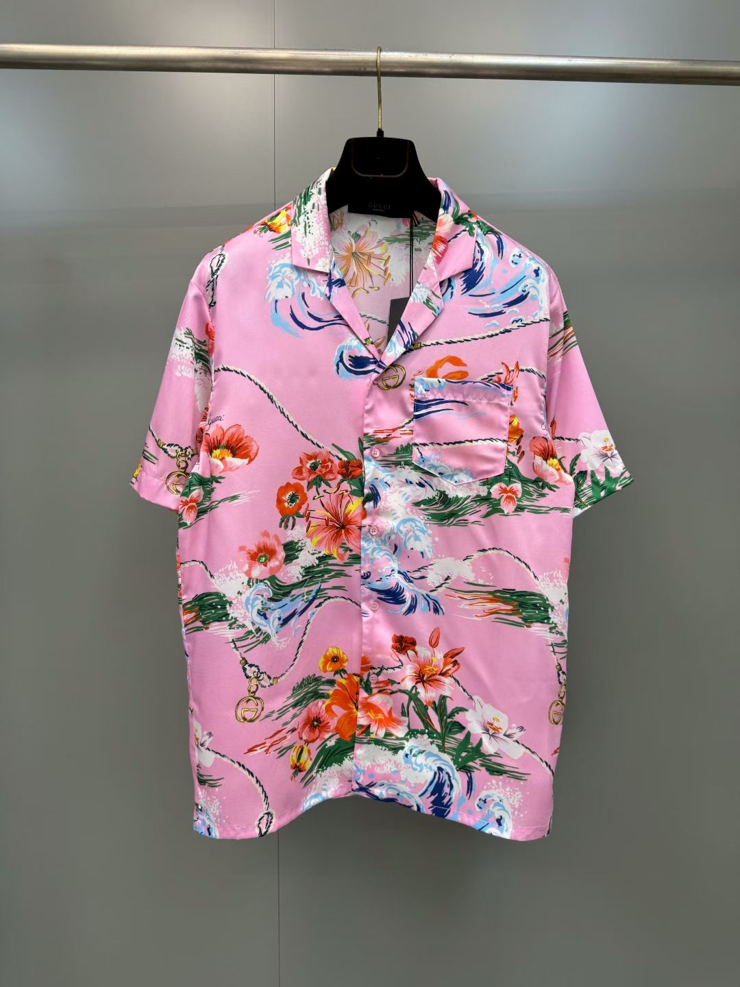 NO:857791,G's retro wave floral print casual short-sleeved shirt  It is made of high-definition mulberry silk blended fabric, tempered by multiple pre-shrinking and sand-washing processes. The texture is silky and smooth, skin-friendly and breathable, and feels warm and luxurious to the touch. The body of the garment is made of high-activity environmentally friendly digital direct-injection technology. The retro wave floral print on the front is delicate and lifelike. The waves, flowers, ropes and brand logo elements are rich and natural, and the color transition is soft and not harsh, perfectly restoring the brand logo.  Ideal holiday aesthetic atmosphere, the printing has been specially fixed and will not easily crack and fall off after long-term washing; the placket uses resin buttons of the same color, with brand details engraved on the button surface, which is smooth and durable; the cuffs adopt a single-button adjustment design, the routing is smooth and neat, and the cuffs can be adjusted at will., Gucci - Clothing, gucci, gucci, shirts, T-shirt,19860909G家复古海浪花卉印花休闲短袖衬衫 采用高定桑蚕丝混纺面料,经多重预缩与砂洗工艺淬炼,质地丝滑垂顺、亲肤透气,上手触感温润高级；衣身采用高活性环保数码直喷工艺,正面复古海浪花卉印花笔触细腻逼真,海浪、繁花、绳索与品牌标识元素层次丰富自然,色彩过渡柔和不生硬,完美还原品牌标志性的度假美学氛围,印花经特殊固色处理,久洗不易开裂脱落；门襟采用同色系树脂纽扣,扣面刻有品牌细节,开合顺滑耐用；袖口采用单扣调节设计,走线平整工整,可随心调整袖口松紧.,古驰-服装,gucci,gucci,shirts,T-shirt,,Women's clothing