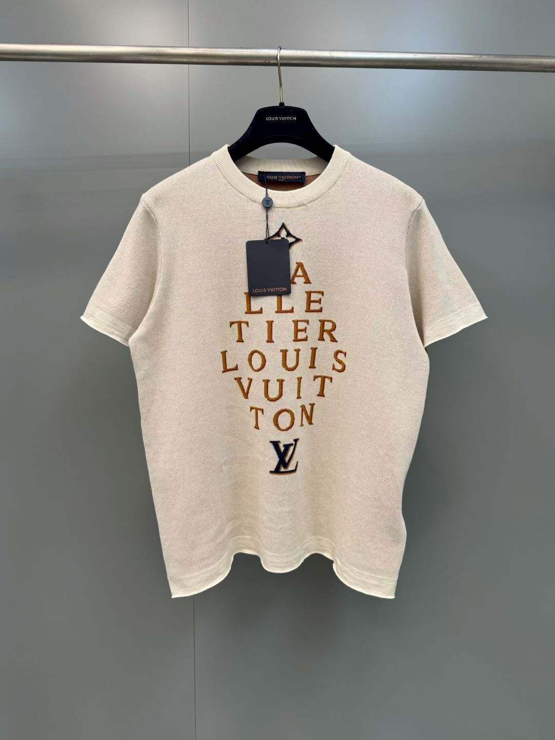 NO:857733,Lujia 26ss new Atelier series letter jacquard knitted short-sleeves, restoring the design language of LV Atelier workshop series, with 'MALLETIER LOUIS' on the front  VUITTON' staggered letter jacquard, with the four-leaf flower on the top and the LV logo on the bottom, restores the retro aesthetics of the brand's workshop culture. The high-density jacquard process restores counter-level details, and the weaving lines are smooth and clear without jumper misalignment; the loose straight version modifies the body shape, whether it is daily casual or street wear, you can easily wear LV's retro high-end sense. Size S.M.L.XL., Louis Vuitton-clothing, louis vuitton, louis vuitton, louis  vuitton,louis vuitton,louis vuitton,T-shirt,19860909驴家 26ss新款Atelier系列字母提花针织短袖,还原LV Atelier工坊系列设计语言,正面采用“MALLETIER LOUIS VUITTON”错落字母提花,搭配顶部四叶花与底部LV标识,还原品牌工坊文化的复古美学.高密度提花工艺还原专柜级细节,织线平整清晰无跳线错位；宽松直筒版型修饰身形,无论是日常休闲还是街头穿搭,都能轻松穿出LV的复古高级感. 码数S.M.L.XL.,路易威登-服装,louis vuitton,louis vuitton,louis vuitton,louis vuitton,louis vuitton,T-shirt,,Women's clothing