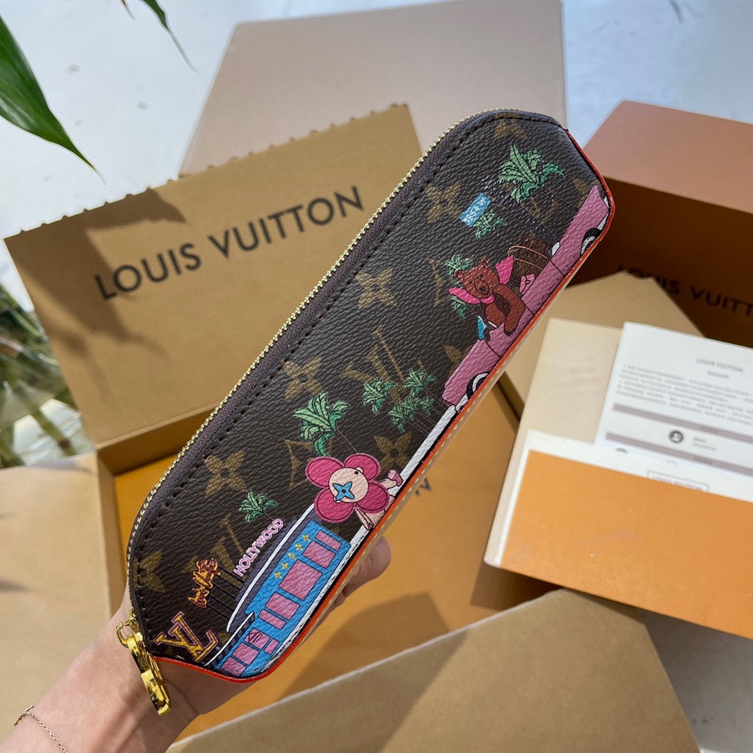 Leather pencil case filled with pens, pencils, and erasers