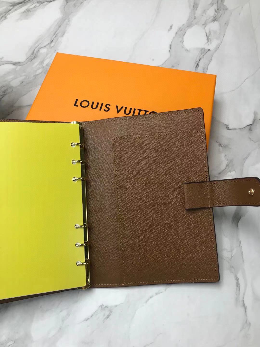 Embossed logo detail on leather notebook