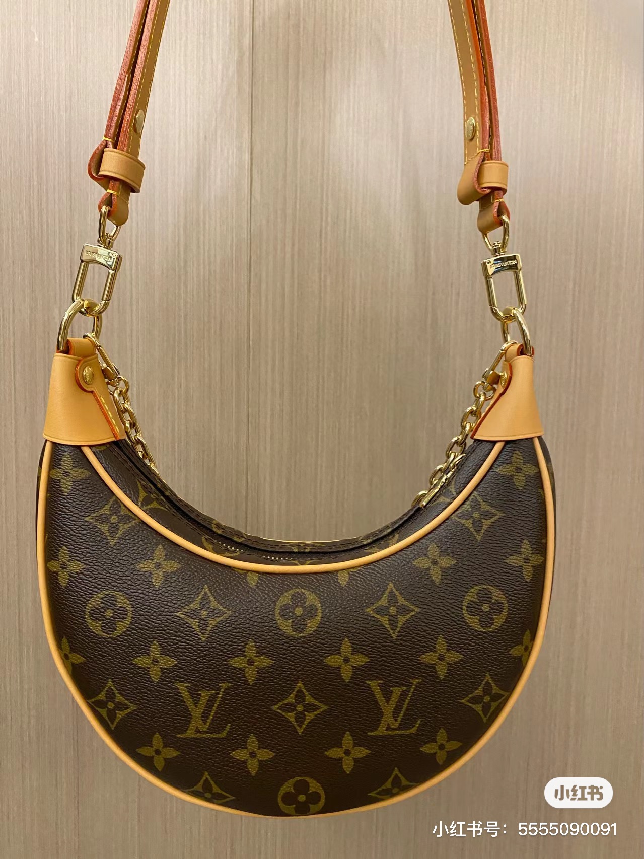 Close-up of hardware on leather crescent bag