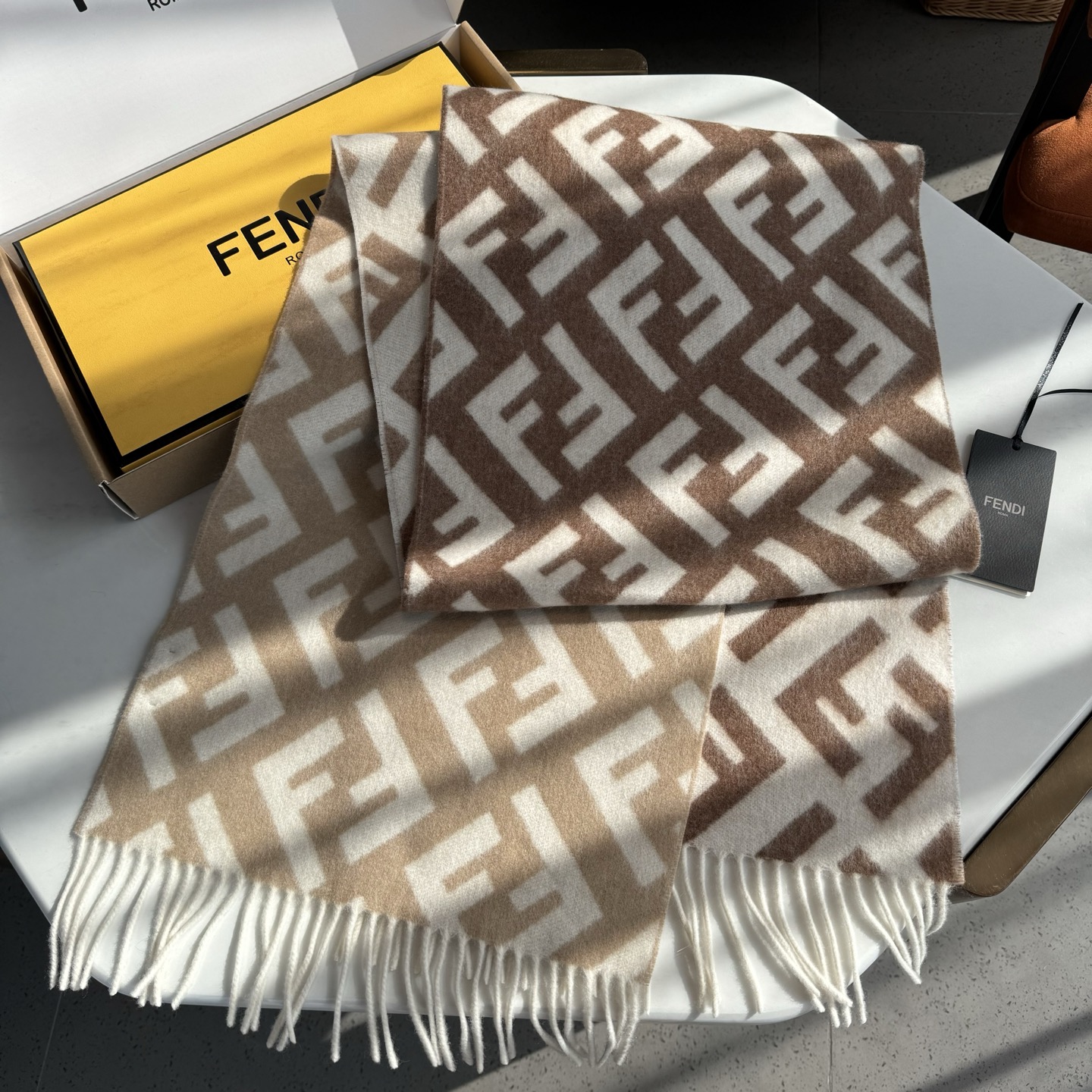 P160 Fendi老花渐变双面羊绒围巾，柔软细腻的双面风格，FF经典提花渐变；柔软的羊绒材质。来自Stefano Pilati合作设计系列。渐变效果以棕色向米色过渡，饰有全幅白色超大号FF图案。超级温柔显气质，高级感满满，原单级品质。美出天际的款式 真的不要错过。规格：35 x180cm ➕流苏长度8cmx2，材质100%羊羔绒，长款流苏围巾，手感柔软亲肤