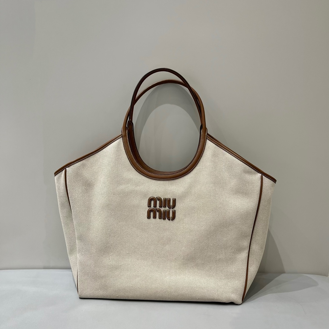 Miu Miu Large MiuMiu Isetan limited edition tote bag. New canvas fabric. Matched with top-grade imported calfskin. Carrying it on the street ever