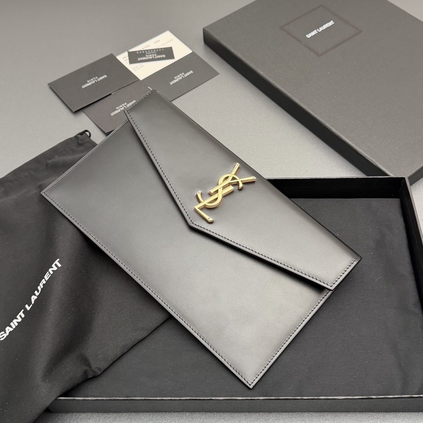 P370【特级五金原厂皮】UPTOWN光滑皮革手拿包
小号信封手拿包，翻盖饰以金属字母标志
牛皮
金色金属配件
磁扣开合设计
内部一个主隔层
编号: 565739   黑色平纹/金扣
尺寸:w27 xh16 xd2cm