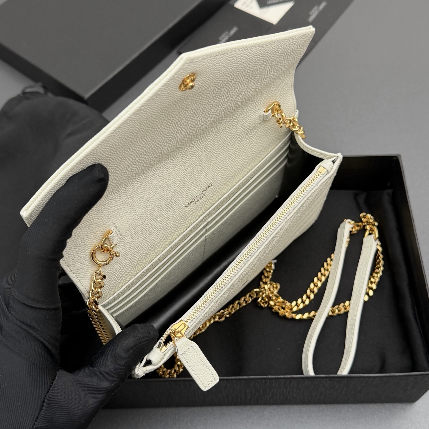 P470【特级五金原厂皮】ENVELOPE粒面皮革链条钱包
隽永链条钱包，标志性V形绗缝明缝线。实用性强，设有一个拉链口袋和多个卡槽。搭配皮革加固链接肩带，可肩背或斜挎携着。
牛皮
金色黄铜金属配件
按扣开合
六个卡槽
一个内部拉链口袋
编号: 393953 白色球纹/金扣
尺寸:w19xh12.5xd4cm