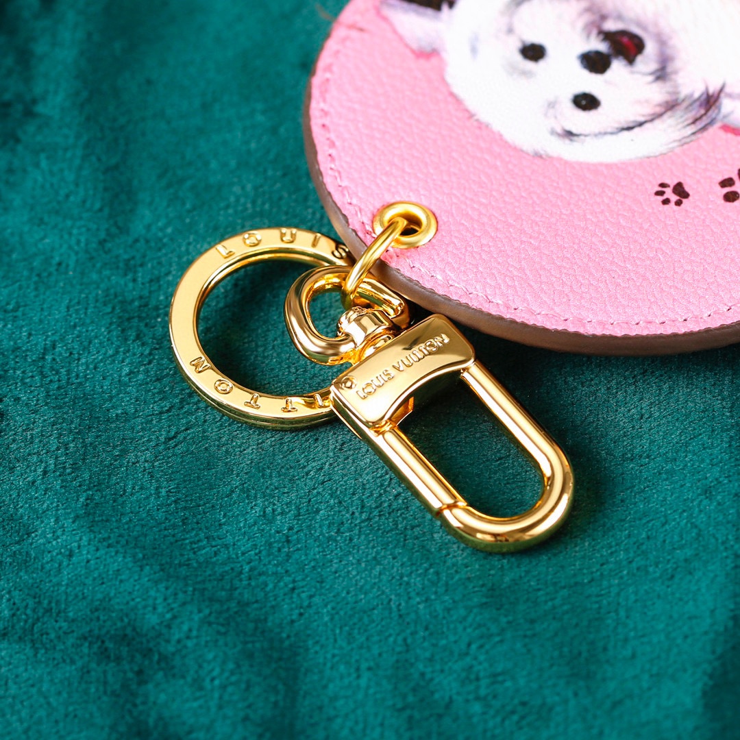 Pink dog keychain in hand
