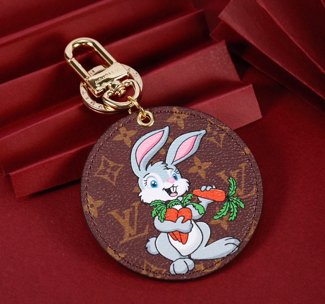 Bunny rabbit keychain with a coffee-colored background, gold clasp, and a bunny design.