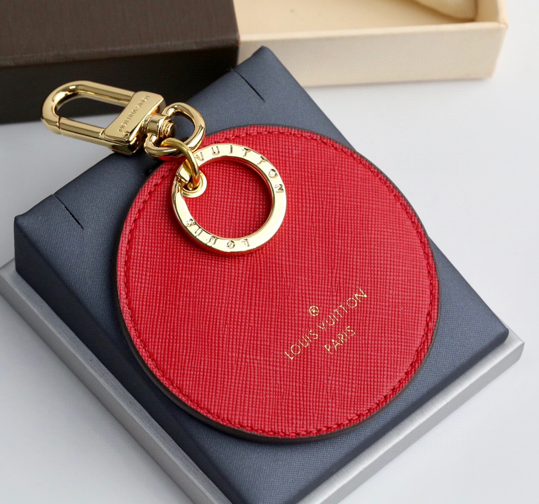 Angle view of the coffee-colored round bumper car keychain.