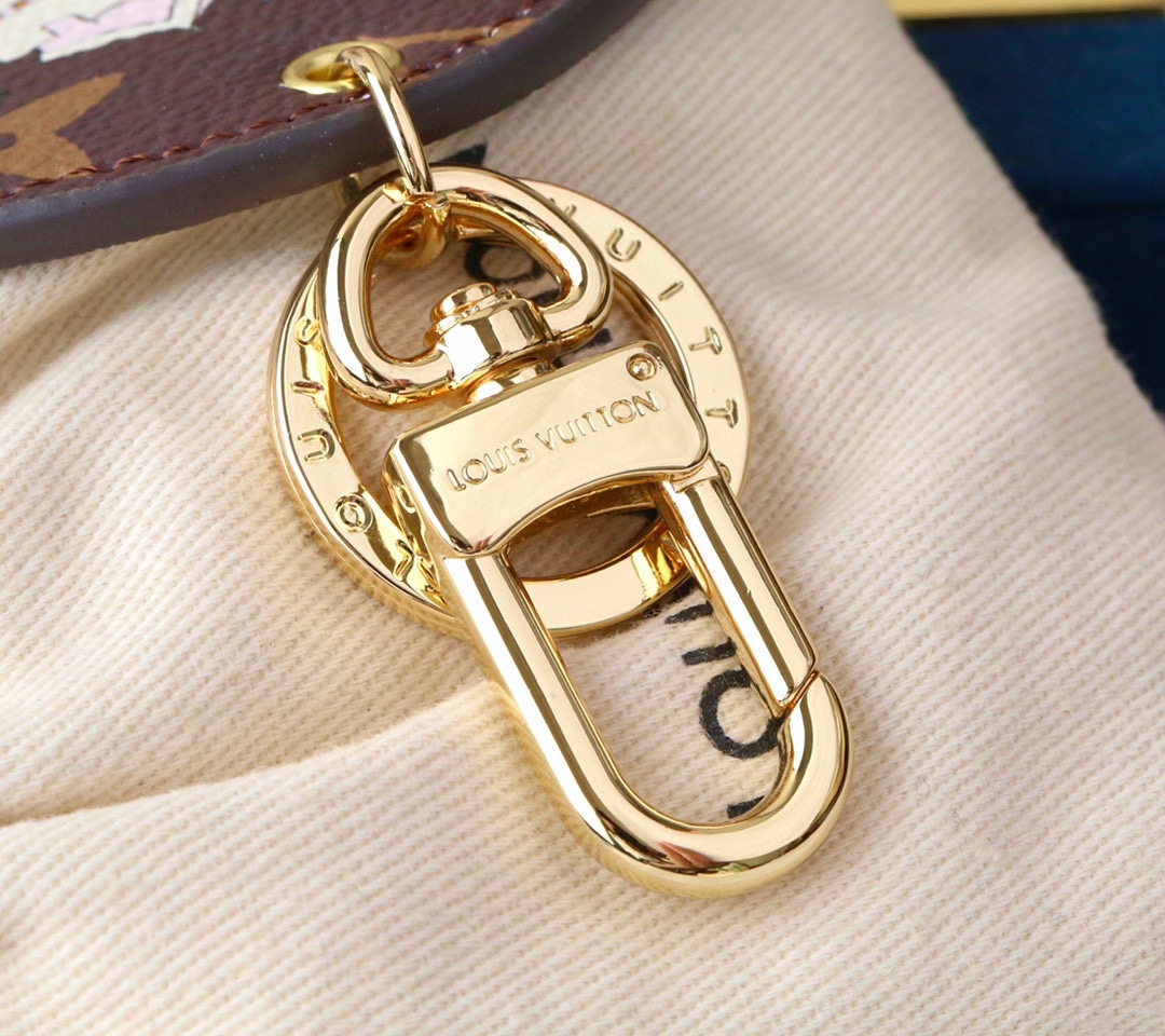 Close-up of a cute panda on a round coffee-colored pendant.