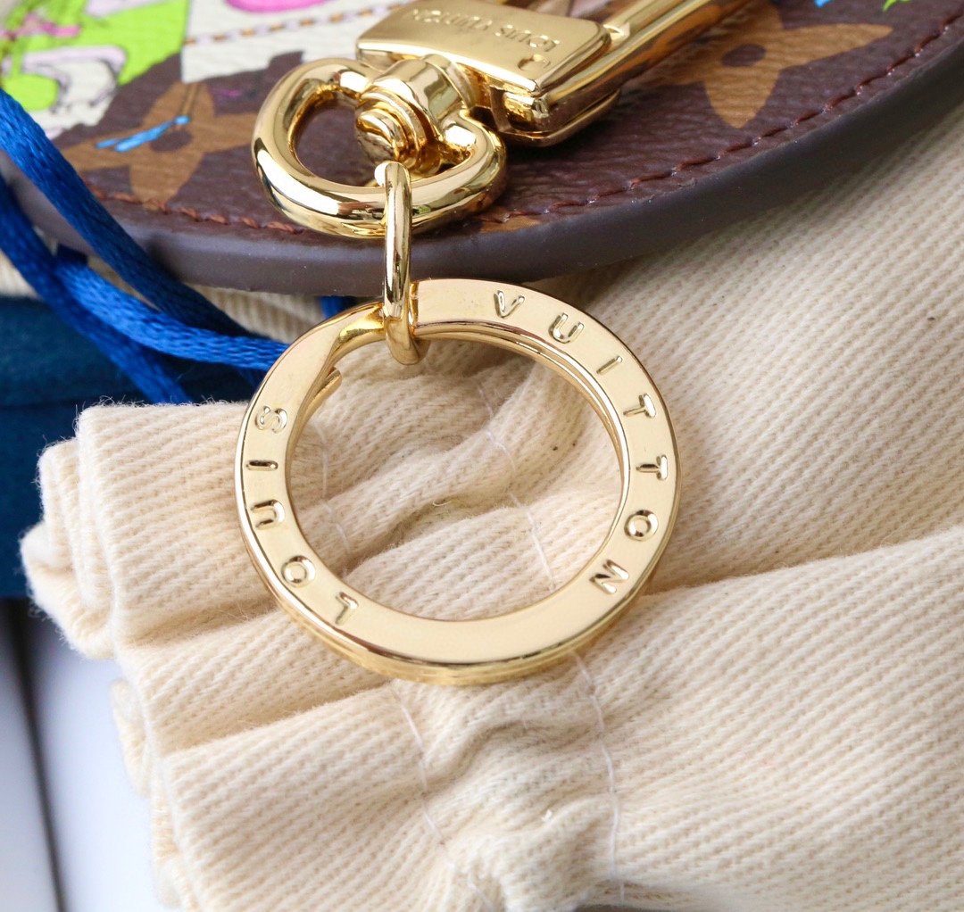 Angle view of the coffee-colored round panda keychain.