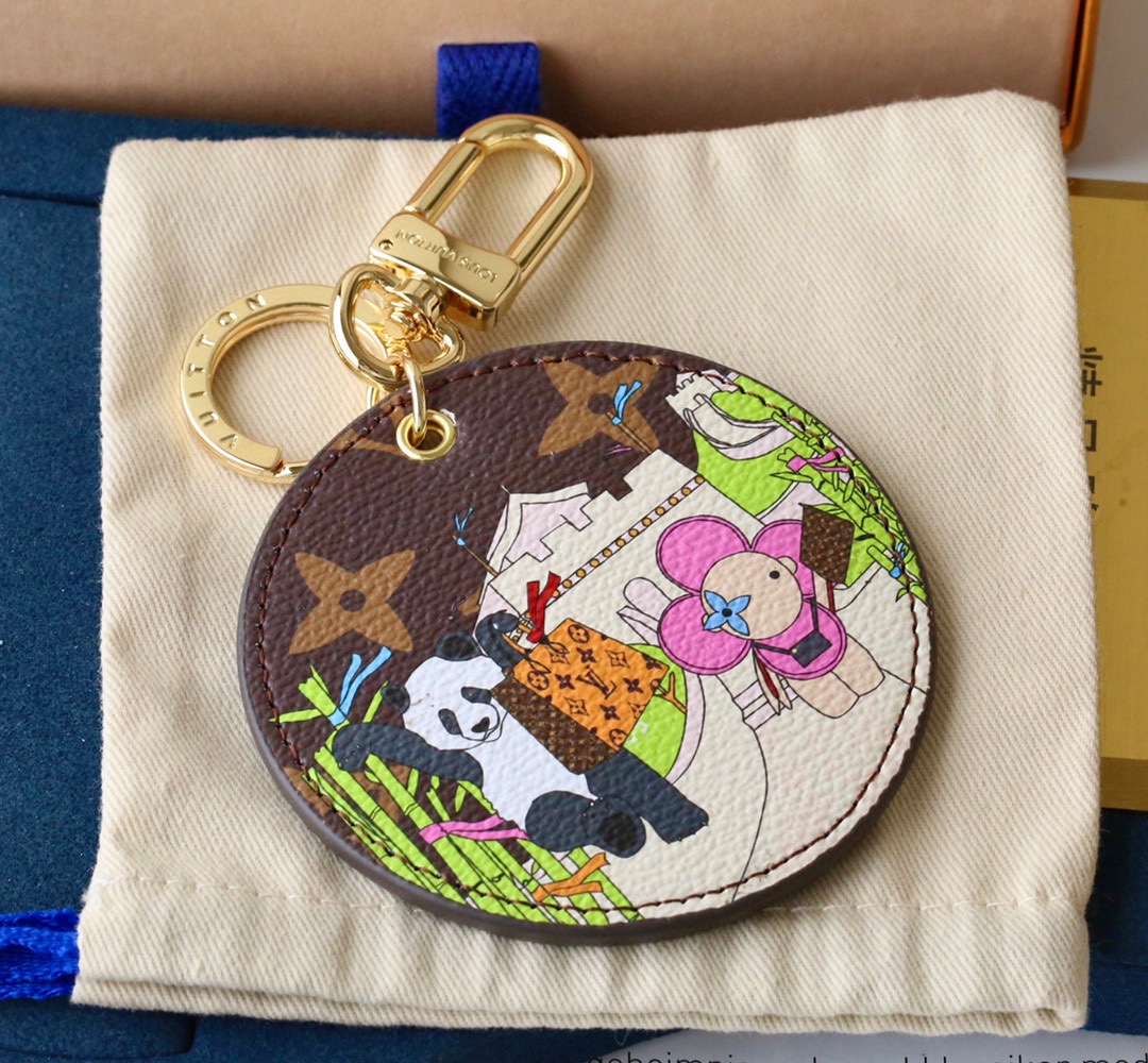 Panda bear keychain with a coffee-colored background, gold clasp, and a panda design.