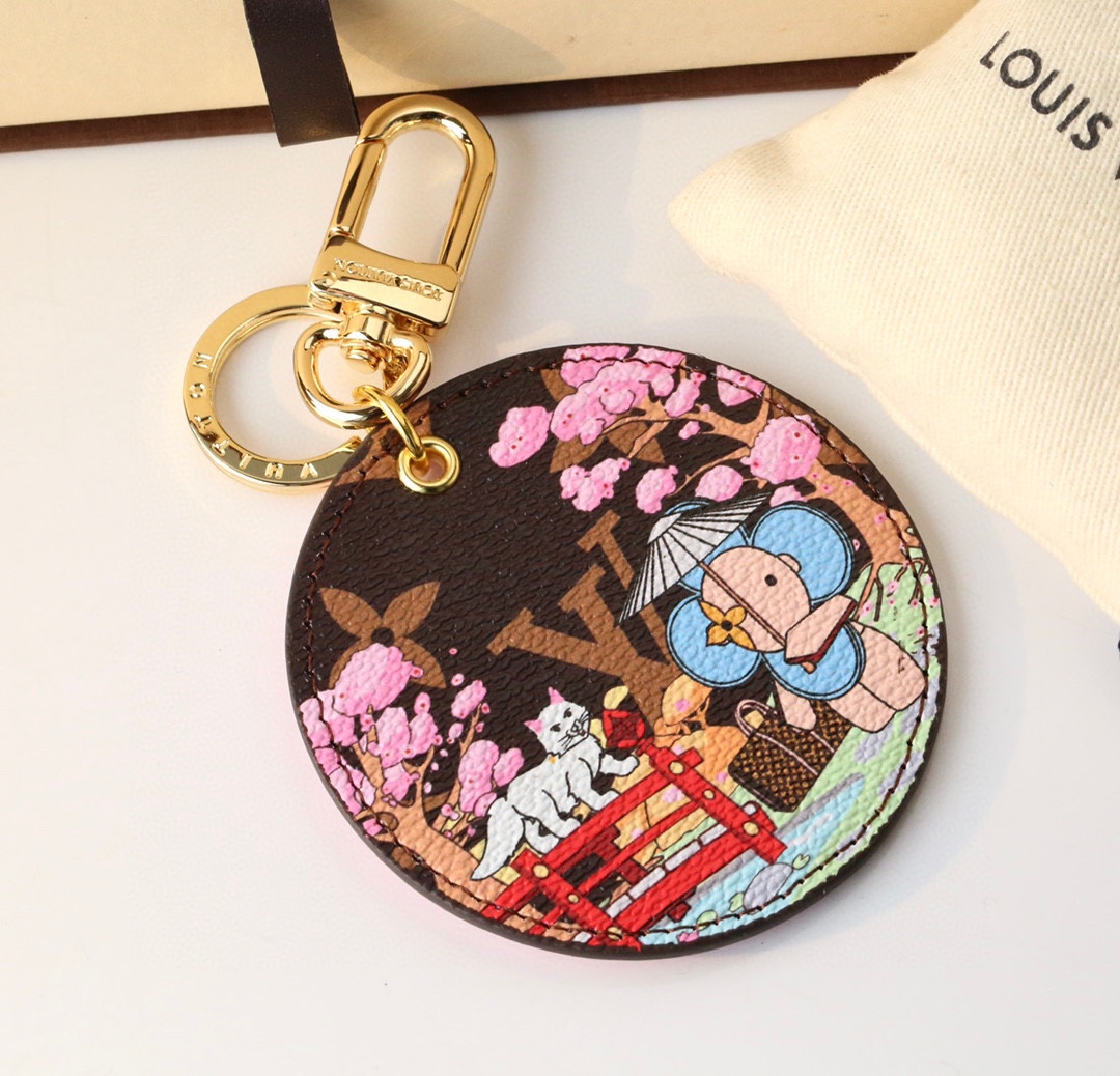 Cherry Blossom Cat keychain with a coffee-colored background, gold clasp, and a cat with cherry blossom design.