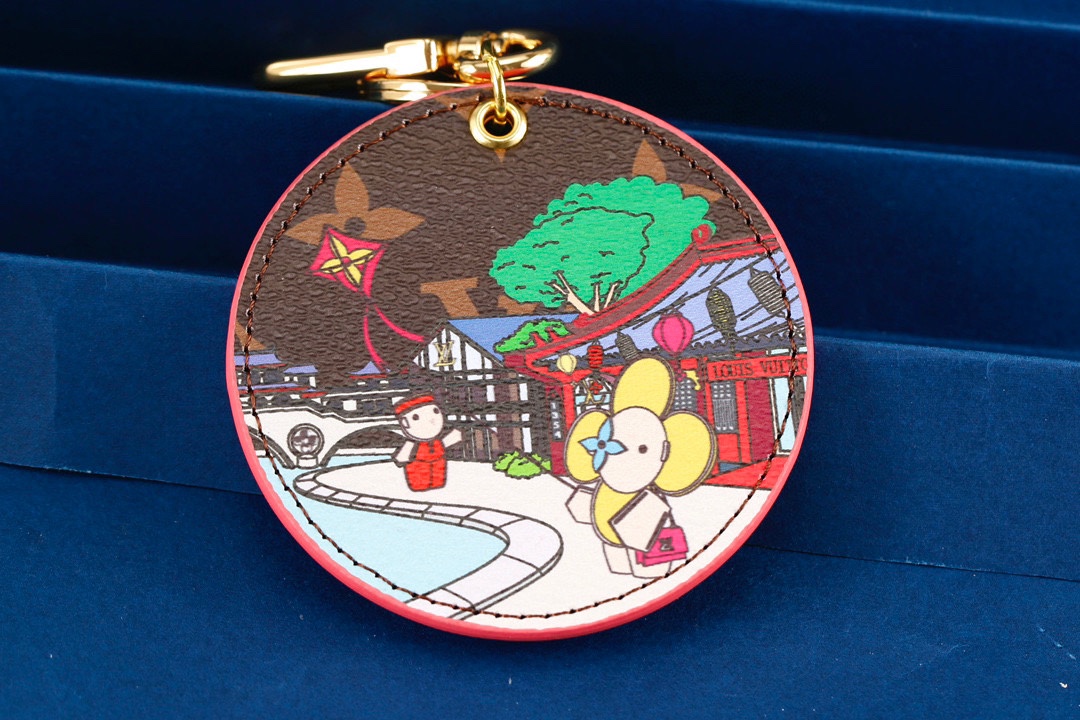 Back view of the leather kite keychain showing gold hardware and attachment ring