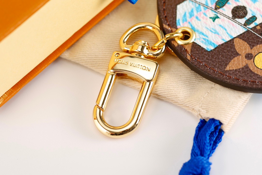 Leather travel keychain attached to a piece of luggage