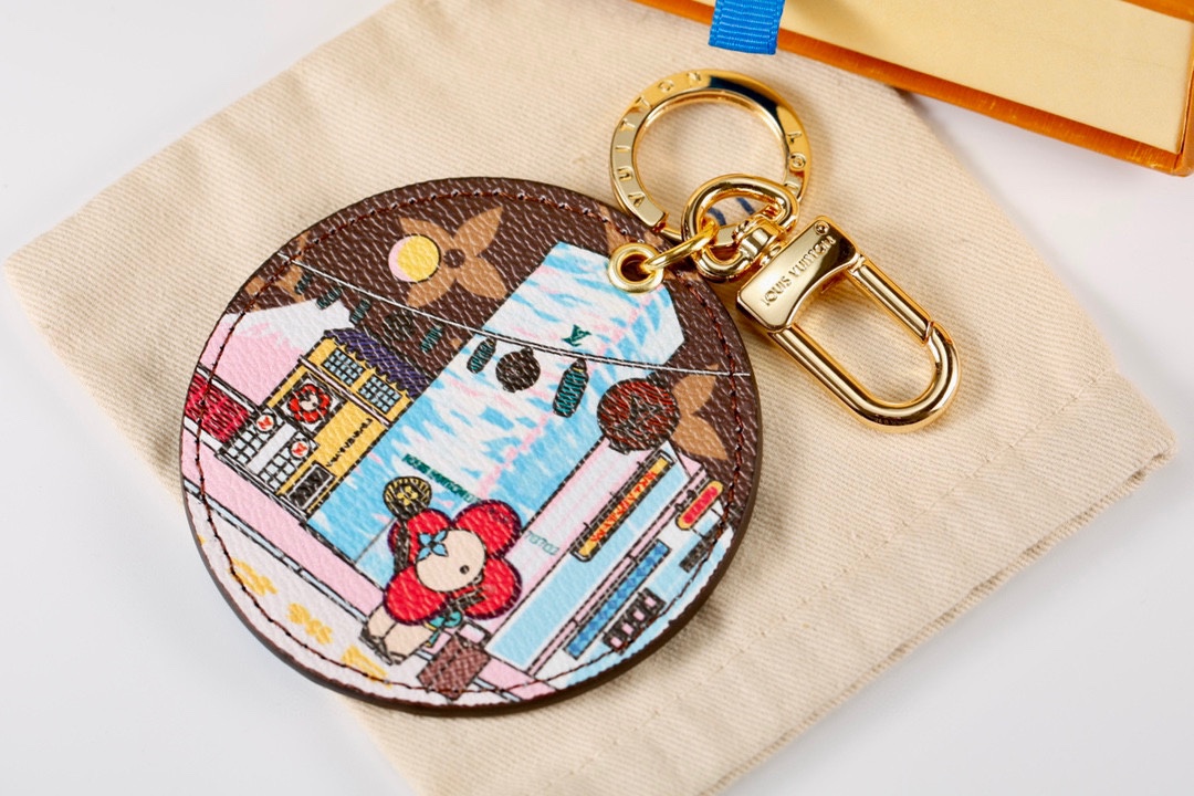Back view of the leather travel keychain showing gold hardware and attachment ring