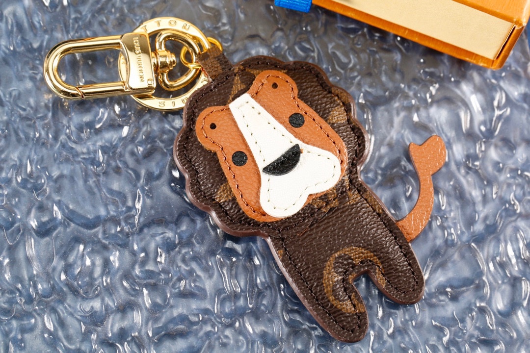 Front view of a coffee brown leather lion keychain