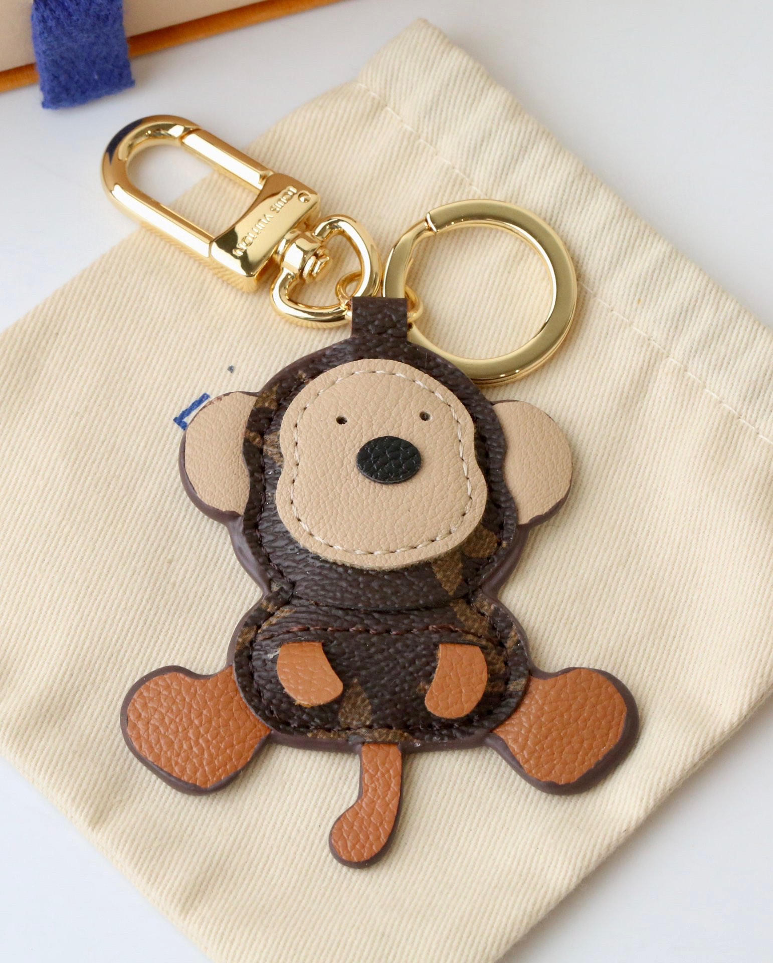 Front view of a coffee brown leather monkey keychain