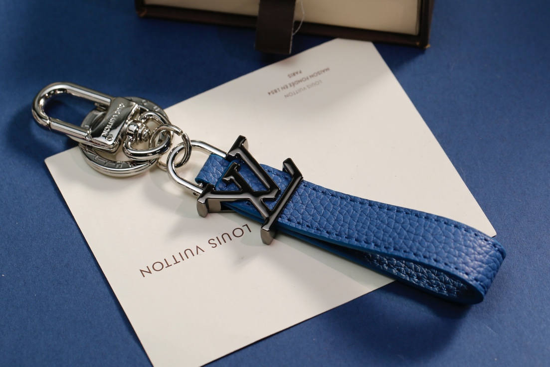 Leather keychain attached to a handbag or bag.