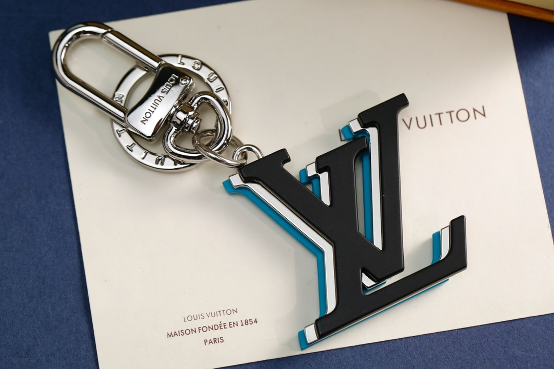Front view of a luxury leather keychain with LV design