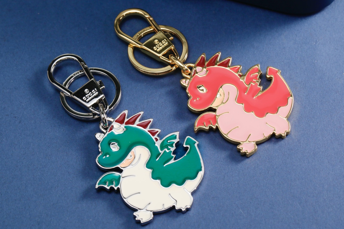 Front view of a leather keychain with a fire dragon design.