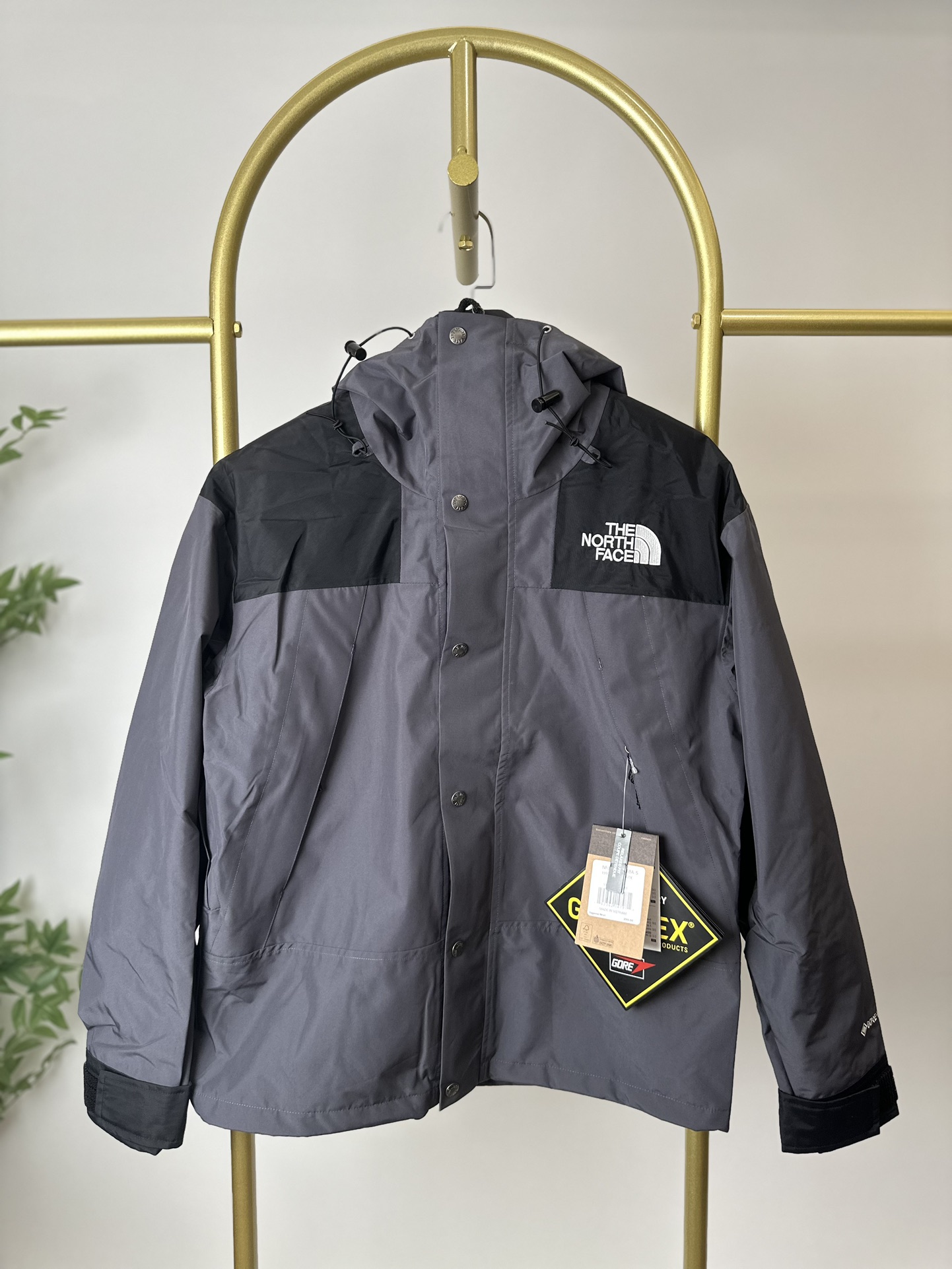 本地 () 顶级版本热压THE NORTH FACE/北面 22FW MOUNTAINJACKETGTX 1990冲锋衣(石墨灰) 带来90年代的功能性风格 美版1990GTX冲锋衣 距离山顶2KM的时候 脱下保暖内胆和背包 向山顶冲刺 所以起名“冲锋衣” 2L双层GORE-TEX面料 面料表层做强度防水 内层已经覆膜 所以到达实现三层防水的效果 使成衣具有防水透气的出色户外效果 领标附加一张以及袖口刺绣证明GORE-TEX面料身份 内衬冲锋衣面料属于功能性面料 防风防水内里设计 上半部分抓绒内里 下半部分尼龙内里 适用温度18°~零下20° 美版为细绒面的棉布内衬塔夫绸和拉绒经编衬里防风面料 质感厚实穿着舒服 薄薄的单层日版单层穿着感会差很远有点像雨衣般 单层的GTX在外观上也会大打折扣容易皱 拼接上幅拉绒面料设计 下幅尼龙面料设计 腋下有通风拉链的设计户外攀登滑雪越野作业时候实现温度自我控制的目的 田岛刺绣工整立体 饱满度立体感以及每个字母的神韵特点 一笔一划工工整整立体效果强烈 正面+背面+肘部贴片和袖口上的标志性色块和织物阻挡提供了高可见度和增加的耐用性