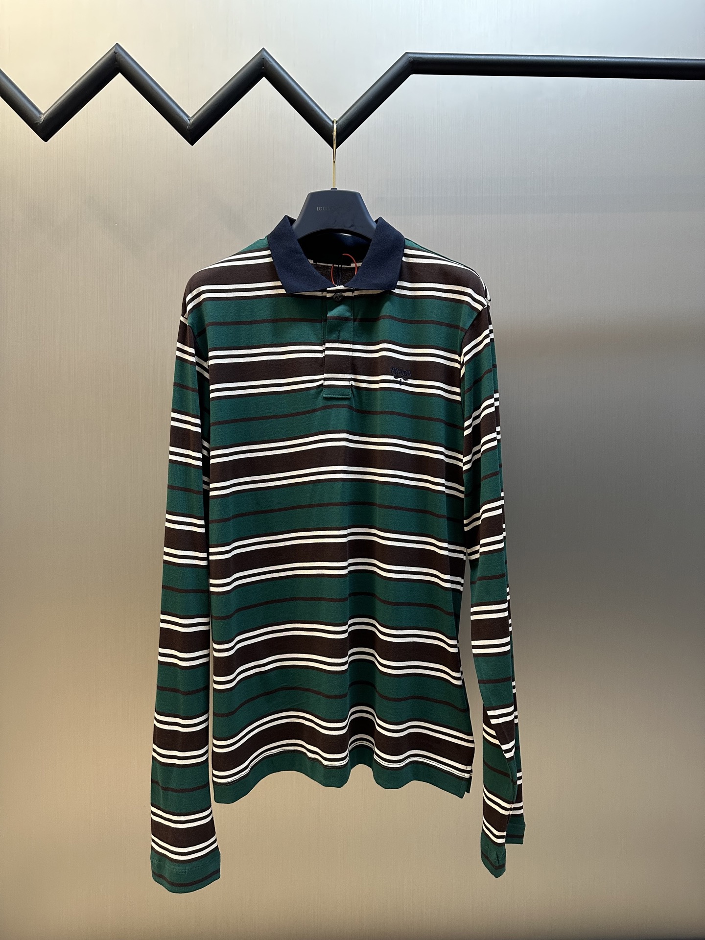 El polo de manga larga a rayas de Prada está confeccionado con un exclusivo material a rayas de doble hebra de 60 hilos…