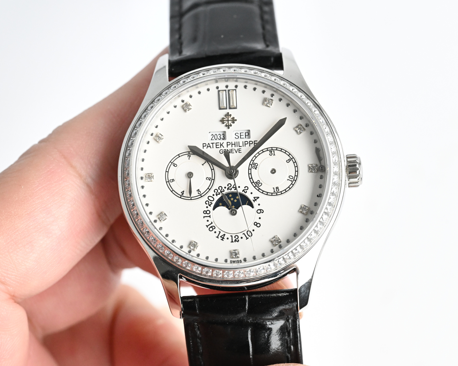 Patek Philippe Complications Annual Calendar Moon Phases 4947 / 200G white gold case with diamond bezel, white dial, black leather strap 38mm Women's Automatic