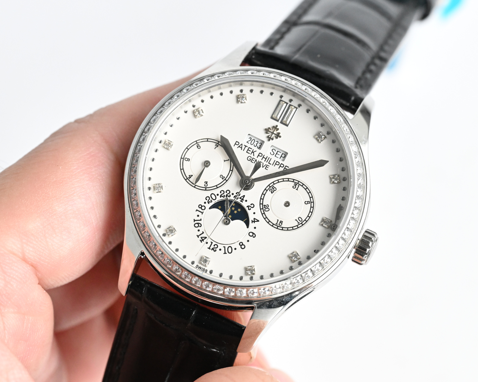 Patek Philippe Complications Annual Calendar Moon Phases 4947 / 200G white gold case with diamond bezel, white dial, black leather strap 38mm Women's Automatic