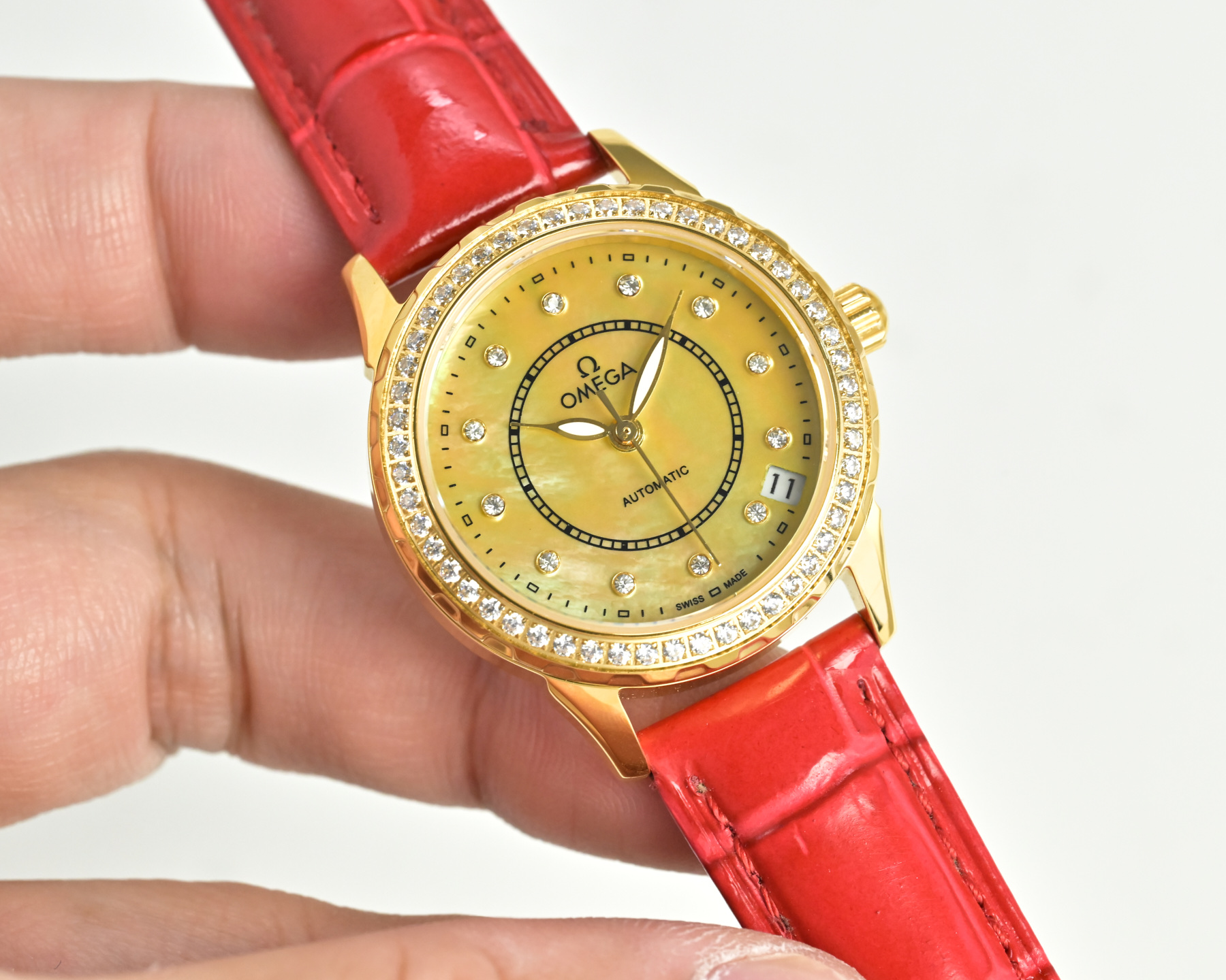 Omega De Ville Prestige gold case, diamond bezel, white dial, red leather strap 27mm Women's Automatic
