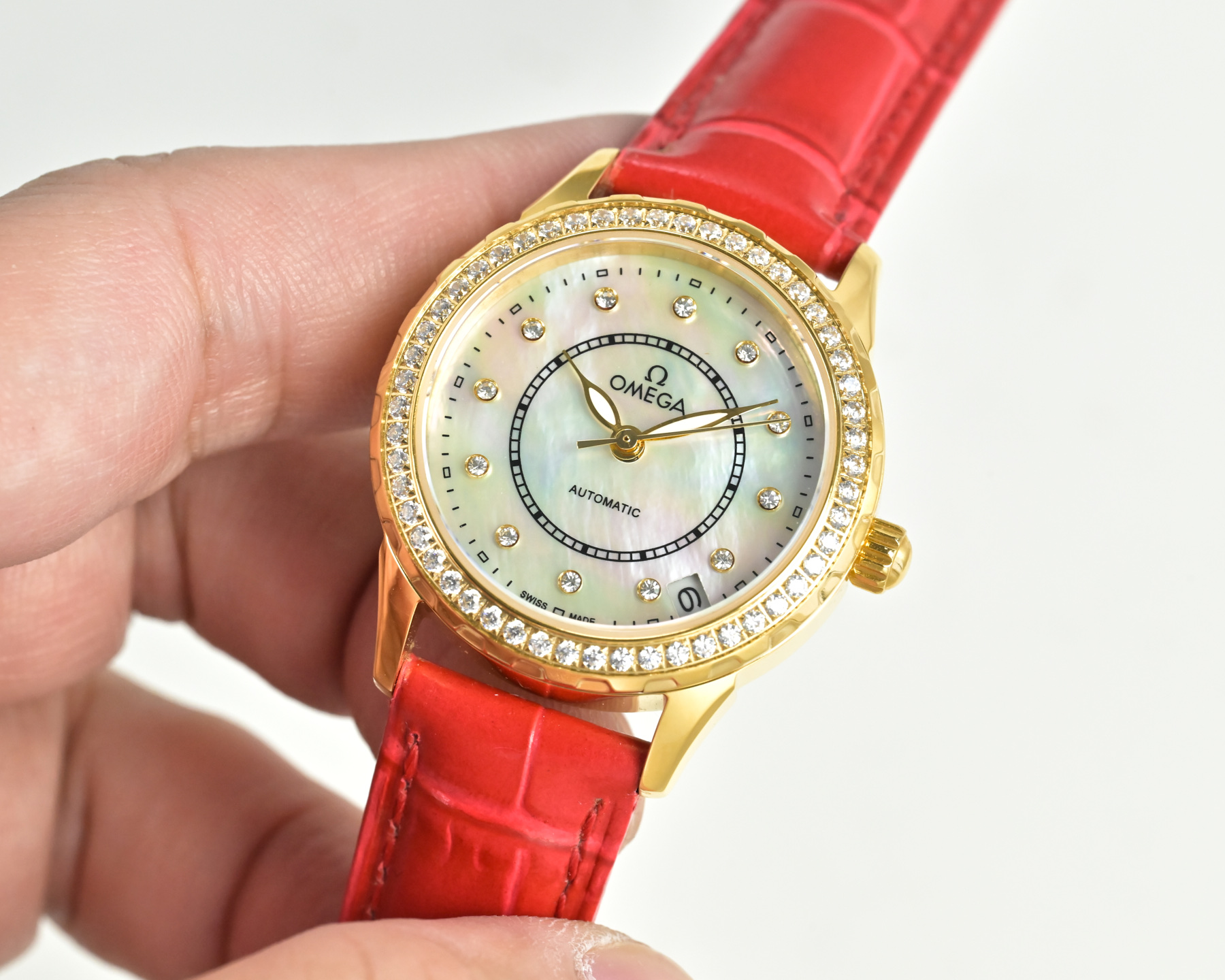Omega De Ville Prestige gold case, diamond bezel, white dial, red leather strap 27mm Women's Automatic