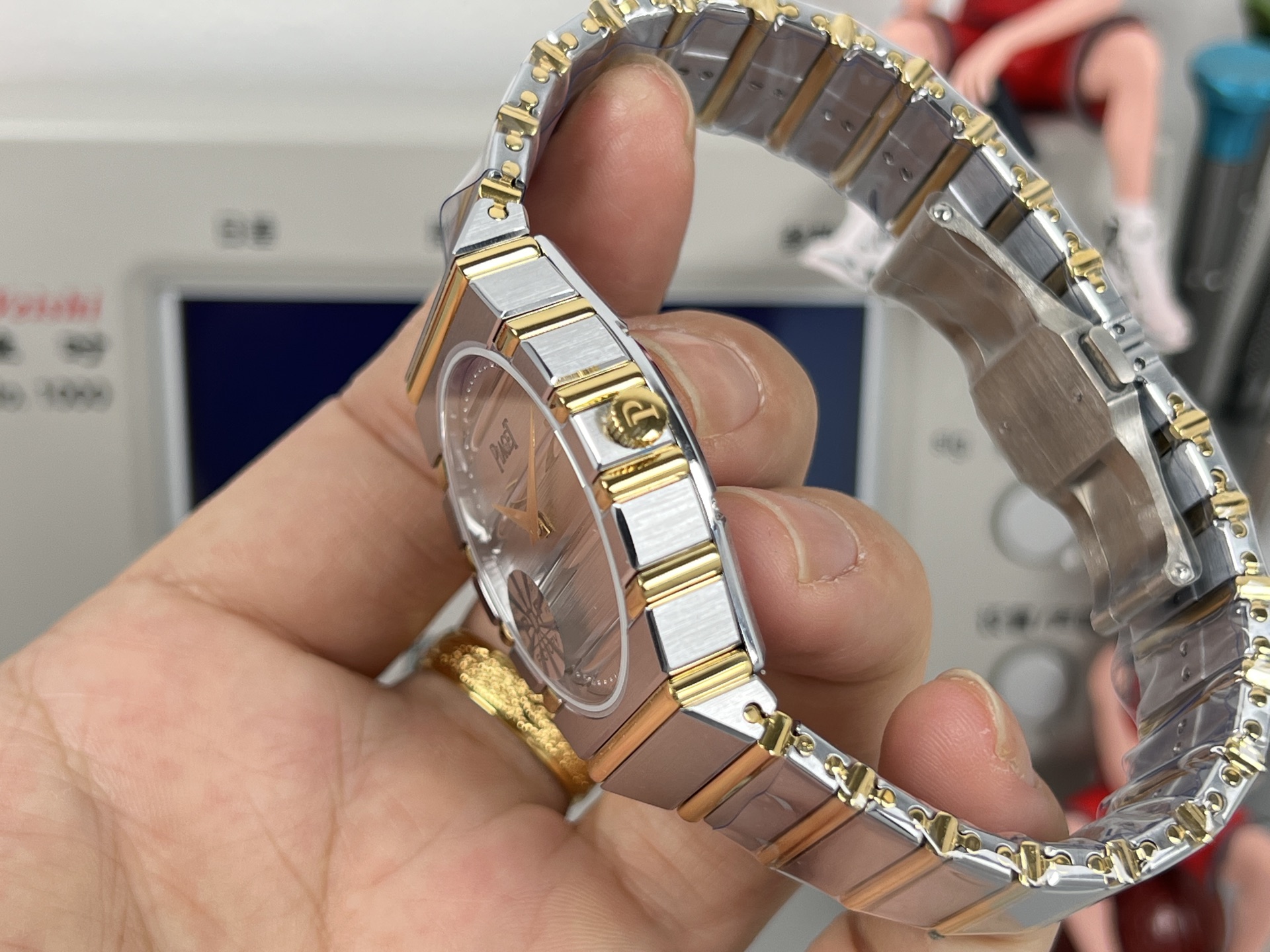 Piaget Possibly Polo or similar oval / tonneau bracelet watch gold-tone case and bracelet, white dial, blue accent 24mm Women's Quartz