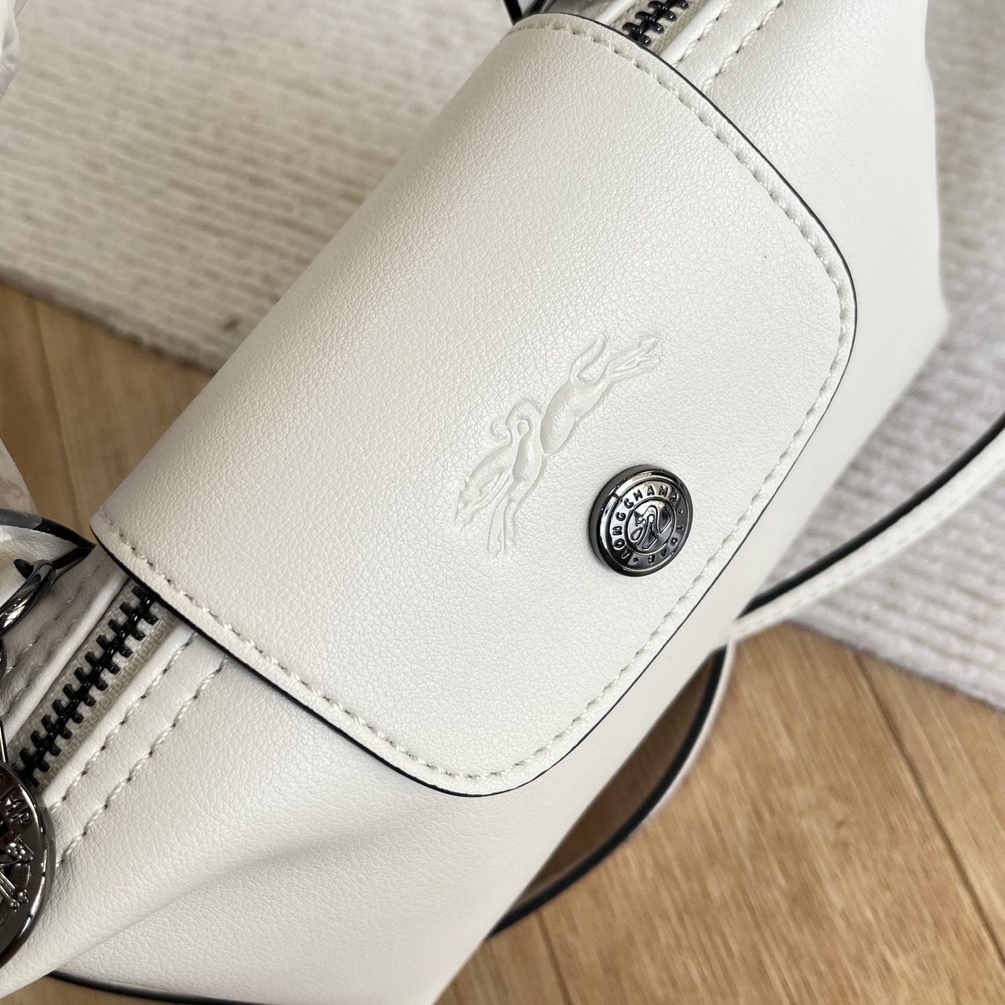 Longchamp Detail of white mini dumpling bag