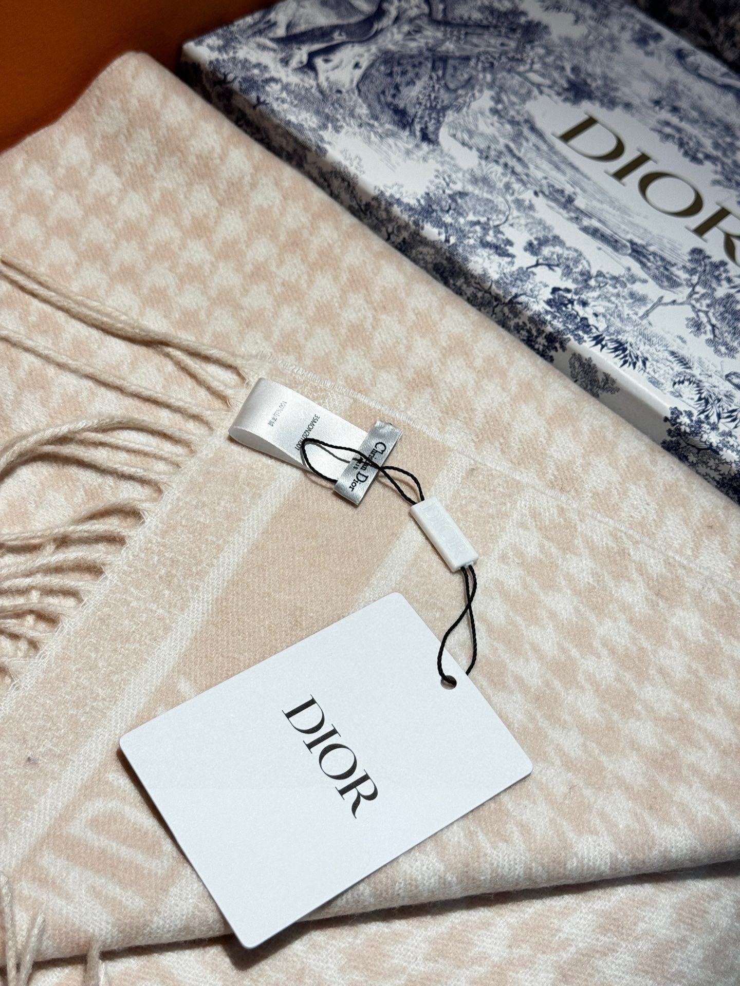 Dior24年新款千鸟格围巾这款围巾向经典的粉色和白色千鸟格纹图案致敬采用羊绒面料精心制作双面设计饰以流