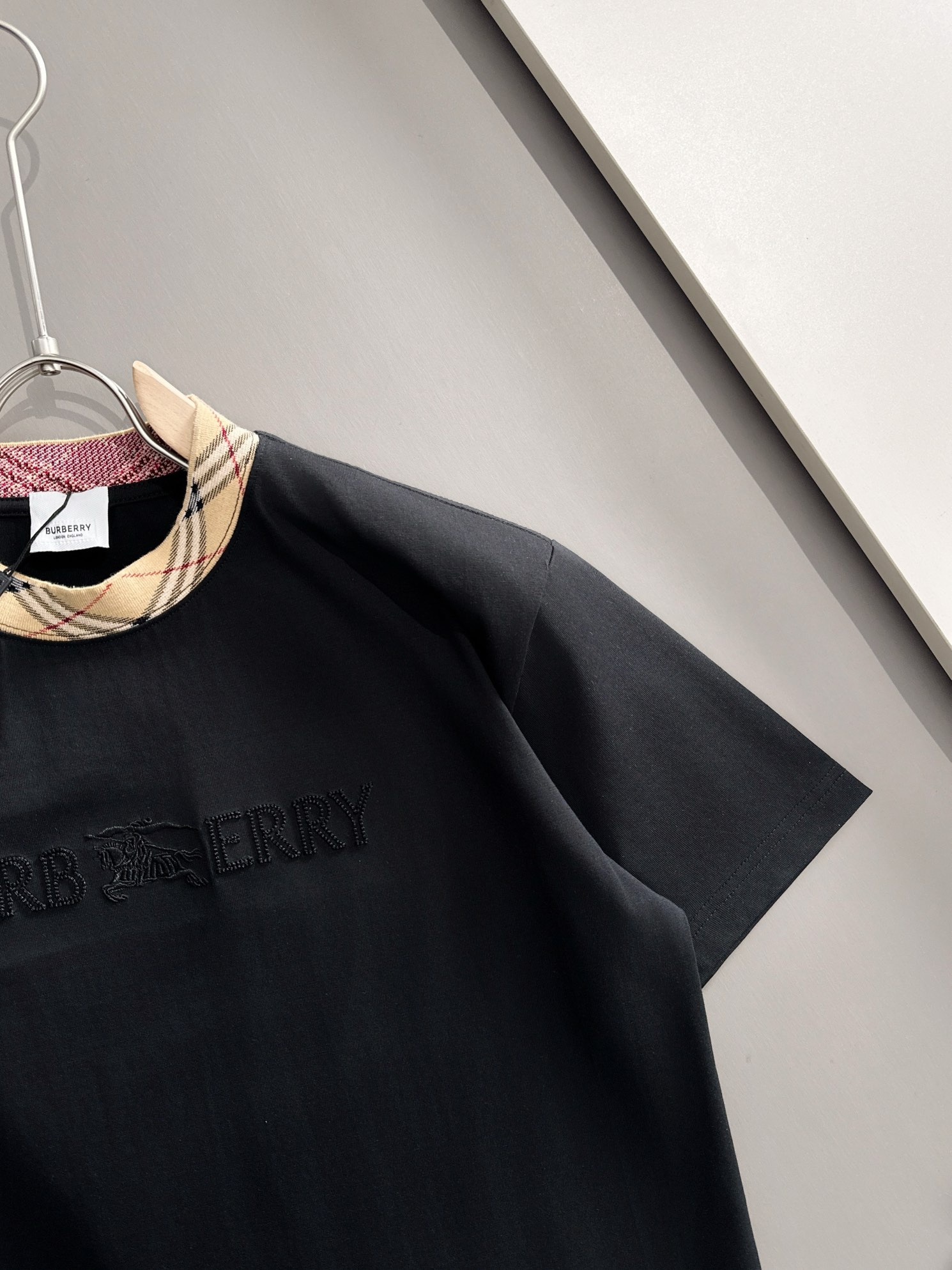 P85

Burberry 巴宝莉 BBR 2026新款 定制经典格纹螺纹领 重工颗粒战马刺绣logo 男女同款 短袖t恤
&middot;定制260克100％双纱纯棉面料
&middot;定染32支双股螺纹
&middot;领标吊牌主唛三标齐全
颜色：黑色
尺码：S M L XL