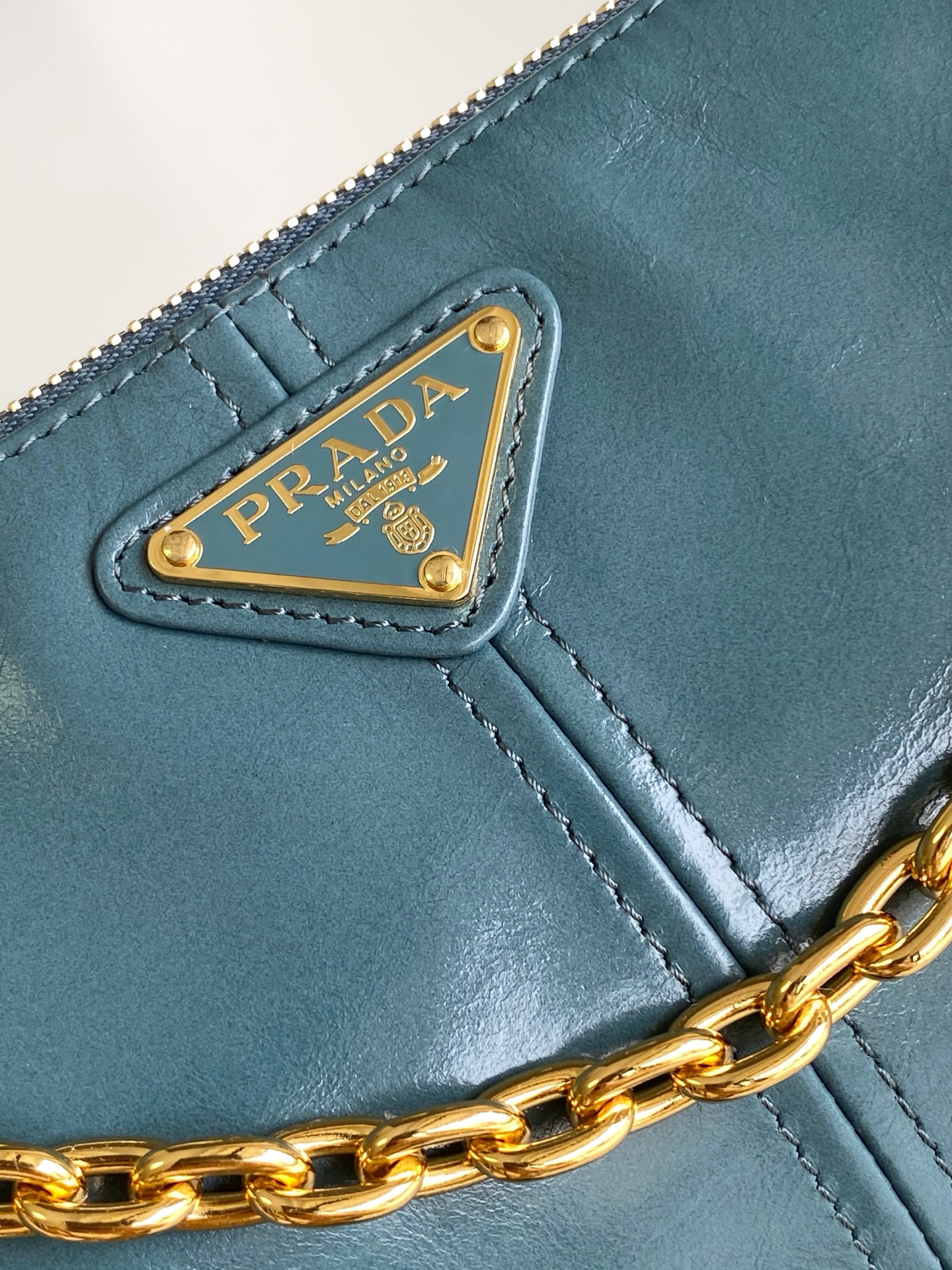 Prada 新款腋下包这款腋下包是2002年 款式的 版 而极简的配饰选用具有 光泽表面的皮革制成