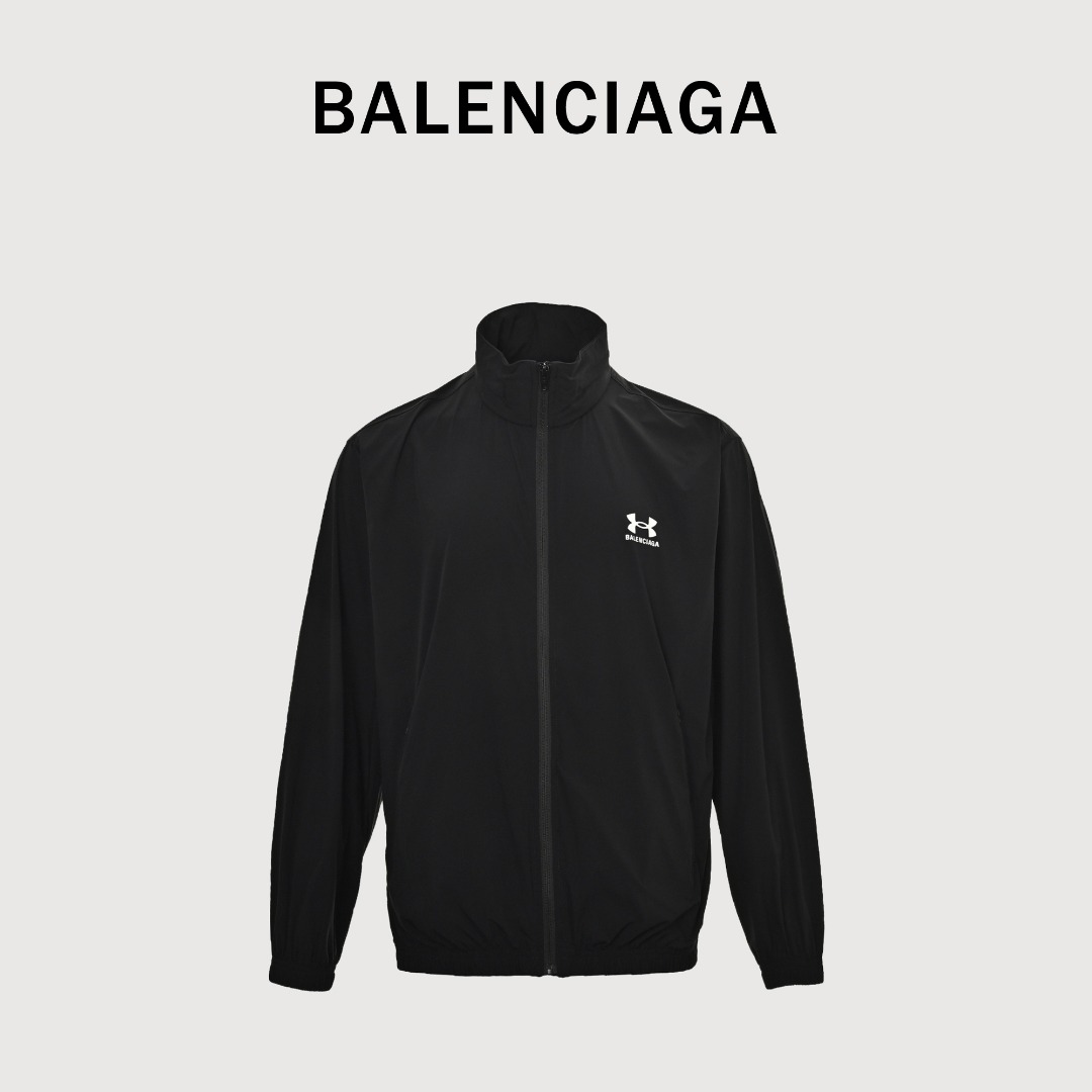 本地自取💰330 BALENCIAGA巴黎世家BLCG 联名款 弹力尼龙连帽夹克外套 面料选用弹力尼龙,由于加入了弹性纤维,使其具有出色的延展性和回弹性,尼龙有天然防水的性能,易于清洗和干燥,抗皱性能好,夹克正面饰以安德玛LOGO和B家字母为主体的胶浆印花,具有良好的耐磨性和耐洗性,后领下方设计了一个隐藏袋,通过拉链开合,因面料轻薄的特性,根据不同需求,可将风帽隐藏或打开,领口处设有圆牛筋帽绳搭配树脂绳头方便调节松紧度,袖口和下摆做了扁牛筋收口,弹性优良,使衣服整体更具线条感。下摆做了圆牛筋松紧带和隐藏的调节绳头,宽松版型 Size:S-XL