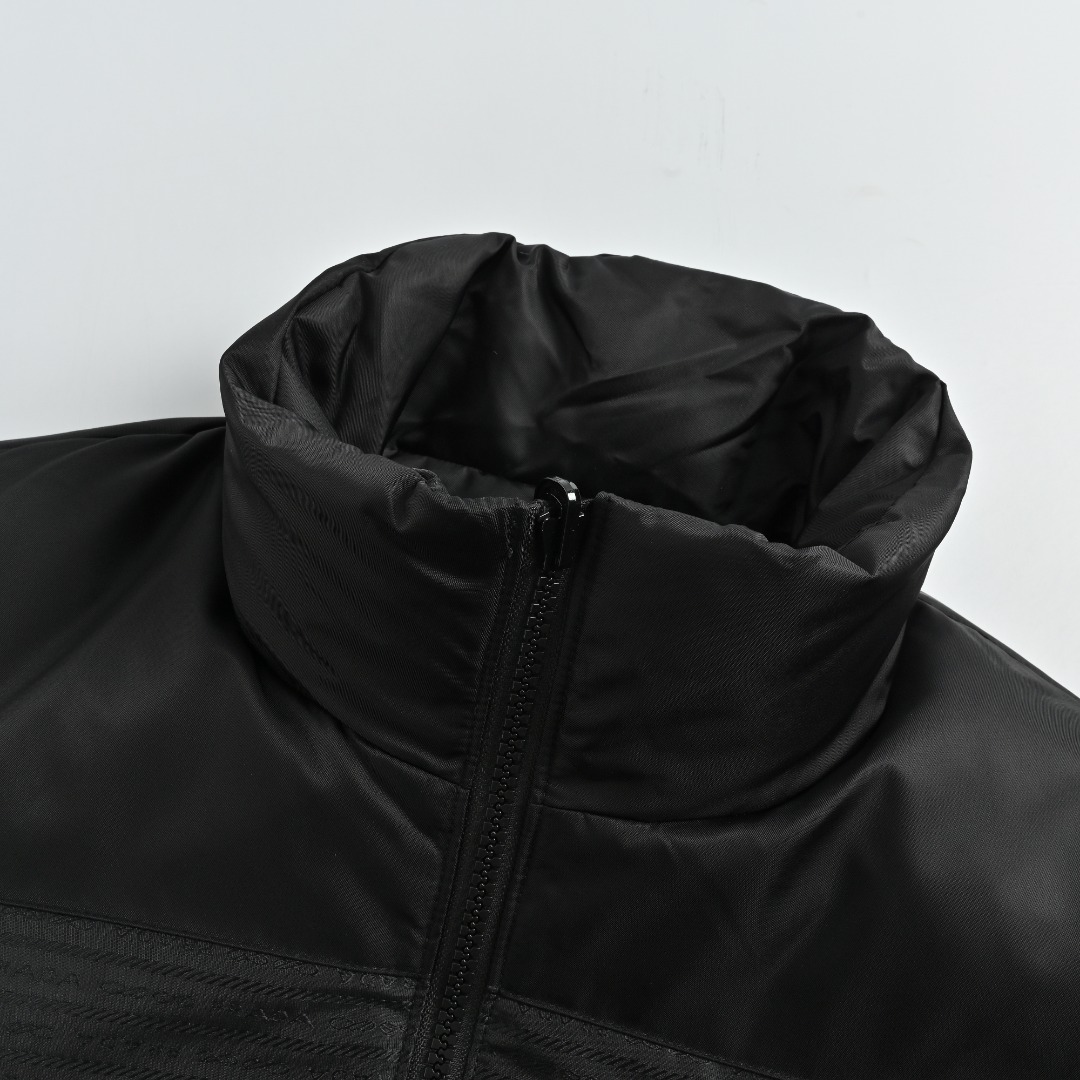 本地自取 💰650 Prada/普拉达 暗纹提花双面穿羽绒服 肩颈部位采用标志性再生尼龙面料,暗纹面料为600T高密度尼龙纤维,经特氟龙涂层处理后防水抗皱,衣身侧边拼接哑光黑缎面,前幅运用Prada标志性暗纹提花工艺,远观呈纯粹哑光黑,近看可见几何线条编织的“隐形图腾”,填充物选用260g 90白鸭绒,保暖性卓越,绒子经严格筛选处理,不易钻绒且耐用,1比1定制辅料三标 Size:46-52