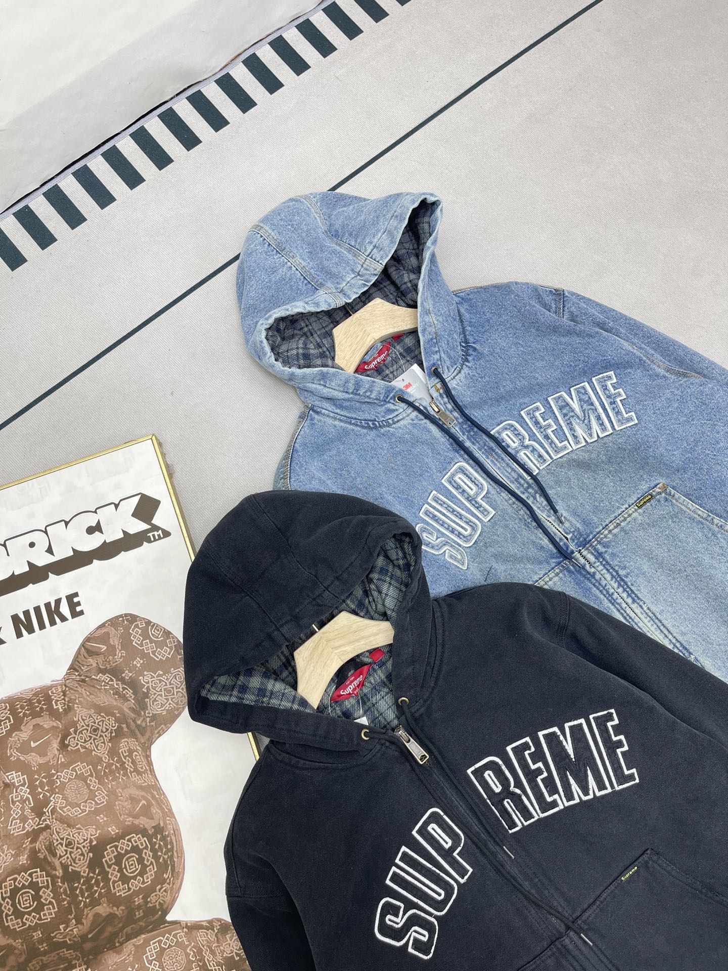 💰460🔥Supreme FW25 WEEK1 Reflective Arc Hooded Work Jacket 反光徽标字母拉链开合连帽工装夹克棉服外套 男女同款
全单宁牛仔面料 绗缝棉法兰绒里衬。正面下方有大口袋，内部胸袋。针织罗纹袖口和下摆。正面有3M®反光与字母徽标贴花。内里格子布千米起订  上身很好看的秋冬新款
颜色：水洗蓝 水洗黑色
尺码：S M L XL
         肩宽    衣长  胸围    袖长
S        58       68     136    66
M       60       70     140    67
L        61       72      144    68
XL      62       74      148    69