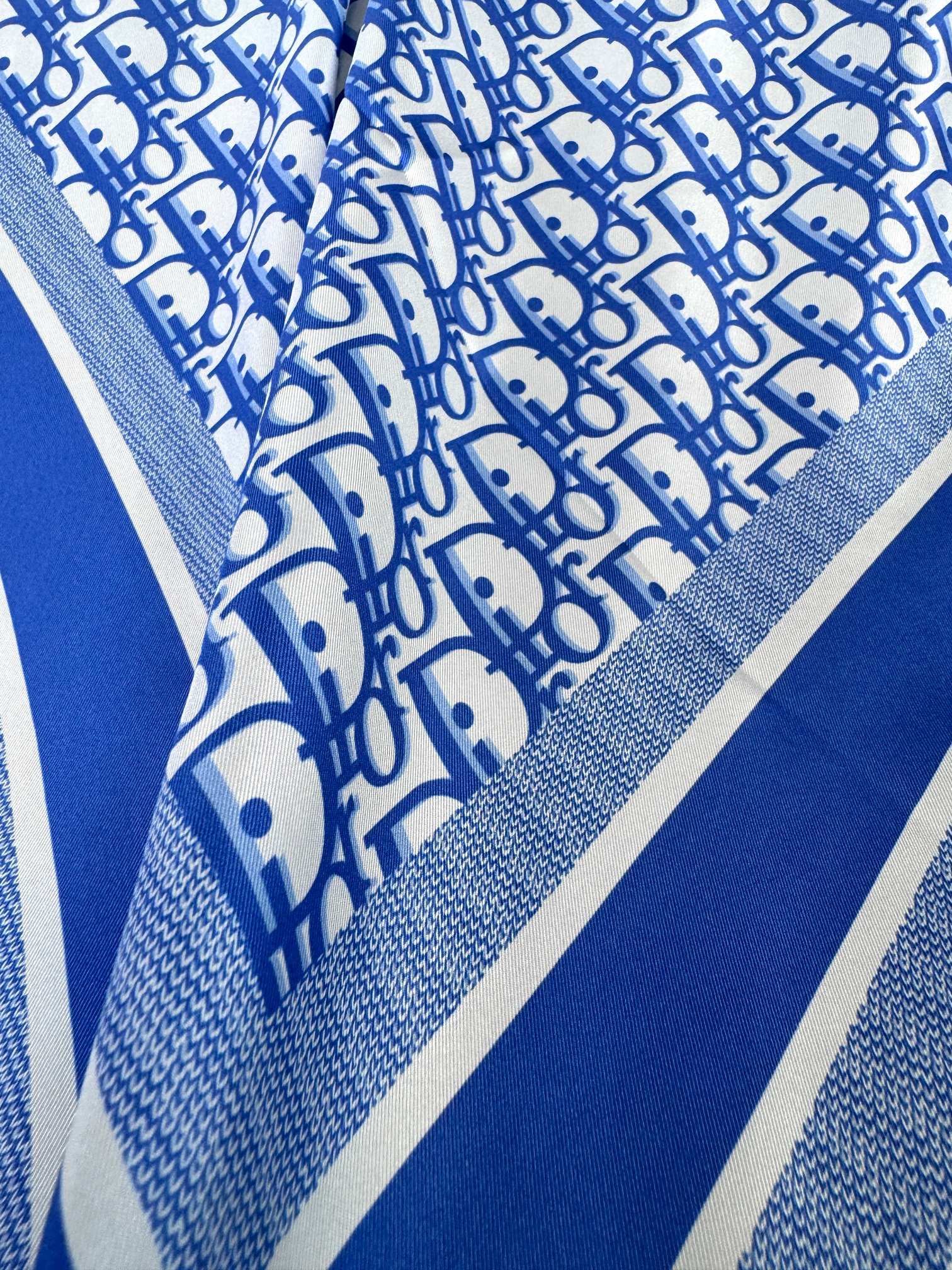 品名:流金字母面料真丝尺寸90*90颜色海军蓝灰色浅蓝这款酒红色方巾以品牌标志性的Oblique印花装饰