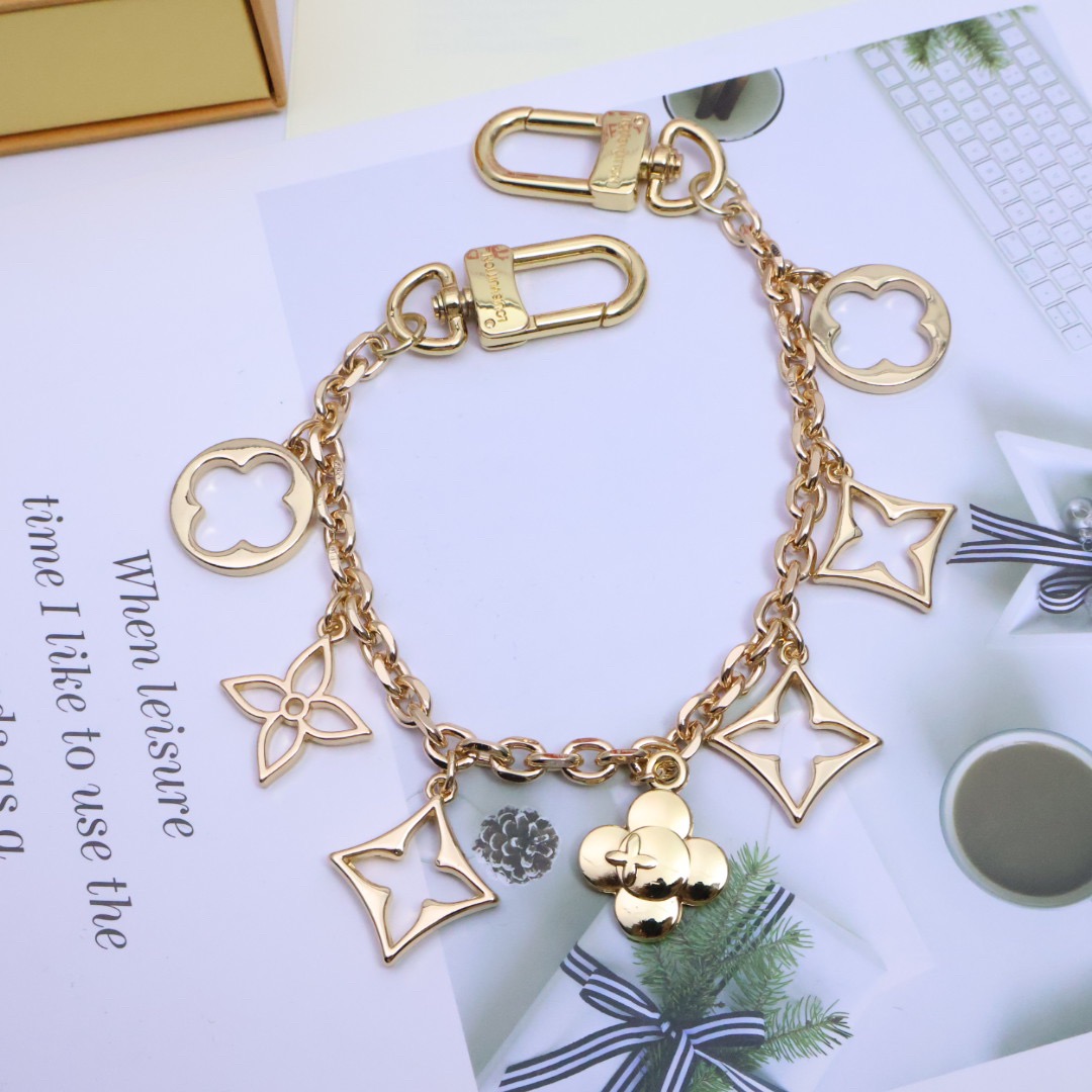 Gold Fleur de Monogram Bag Charm - Side View Gold Fleur de Monogram bag charm side view