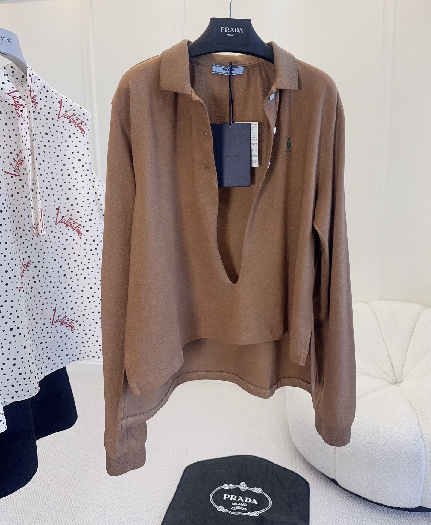 NO:840244,Prada 2026 spring and summer new caramel color Polo shirt, made of piqué cotton, soft and textured, super comfortable to wear!  The loose off-shoulder version is super friendly to the figure. The deep V half-open button design, layered with a white vest, is perfect for layering, casual and fashionable. The green inverted triangle embroidery logo on the chest is low-key and refined, and you must pay attention to details!  The caramel color is white and does not matter the skin tone, and can be easily controlled by yellow skin. It is suitable for daily outings or dates. It is retro and high-end.,,prada,19860909Prada 2026春夏新款焦糖色Polo衫,珠地棉材质,柔软有肌理感,穿着超舒适！宽松落肩版型,对身材超友好,深V半开扣设计,叠穿白色背心层次感满分,随性又时髦.胸口绿色倒三角刺绣Logo,低调精致,细节控必入！焦糖色显白不挑肤色,黄皮也能轻松驾驭,日常出街或约会都很适合,复古又高级感十足.,,prada,,Women's clothing