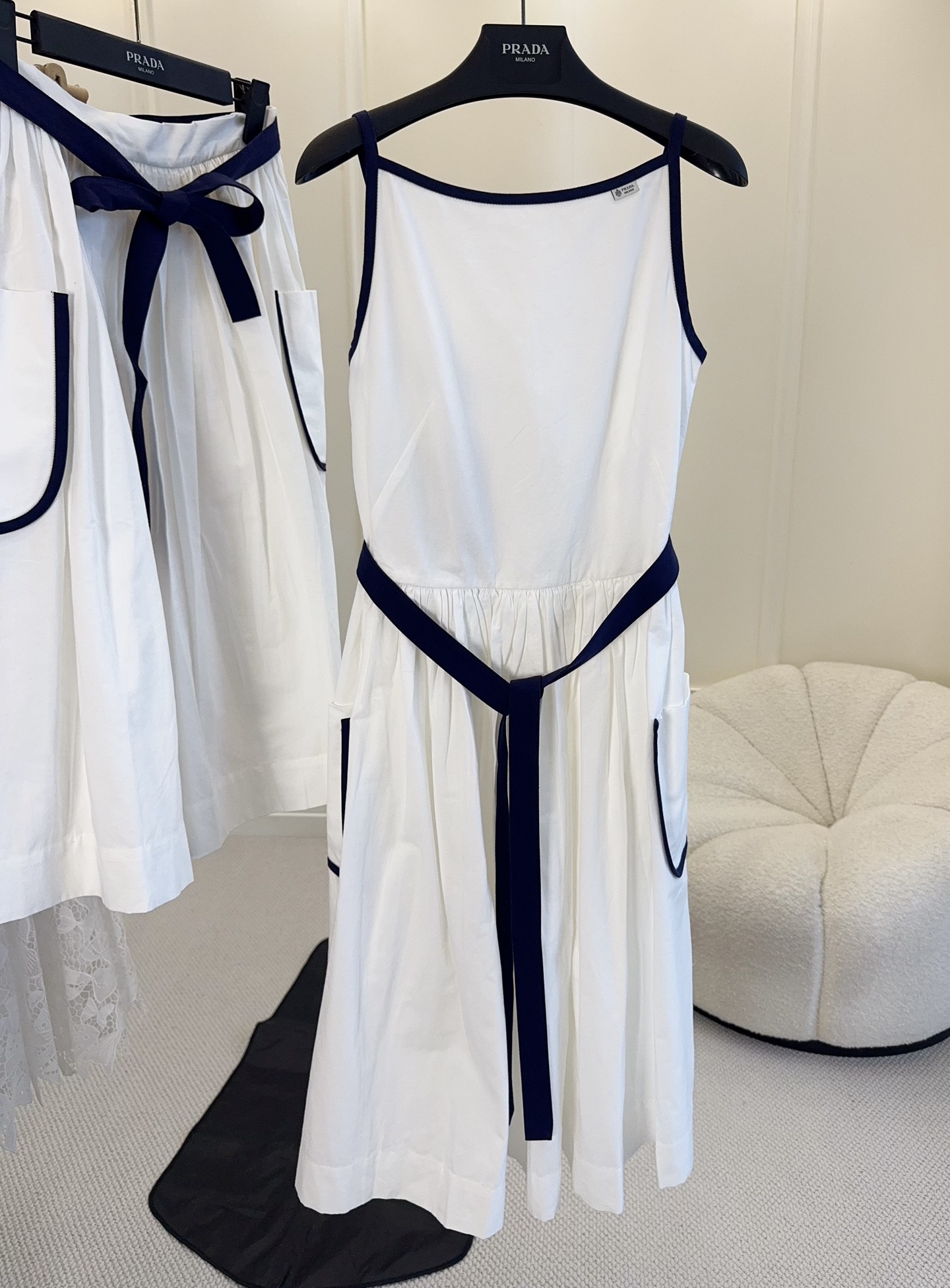 NO:890301,Prada2026 new white sleeveless dress, pure cotton material is super breathable, square collar + navy blue hemming, full of retro feel, bow belt outlines the waistline, looks slim and elegant. There are practical pockets on both sides of the skirt, playful and convenient, can be easily controlled for commuting, dating and daily life, simple and high-end sense~,, prada, skirts,19860909Prada2026新款白色无袖连衣裙,纯棉材质超透气,方领+藏青包边,复古感满满,蝴蝶结腰带勾勒腰线,显瘦又优雅.裙摆两侧有实用口袋,俏皮又方便,通勤、约会、日常都能轻松驾驭,简约高级感拿捏住啦～,,prada,skirts,,Women's clothing