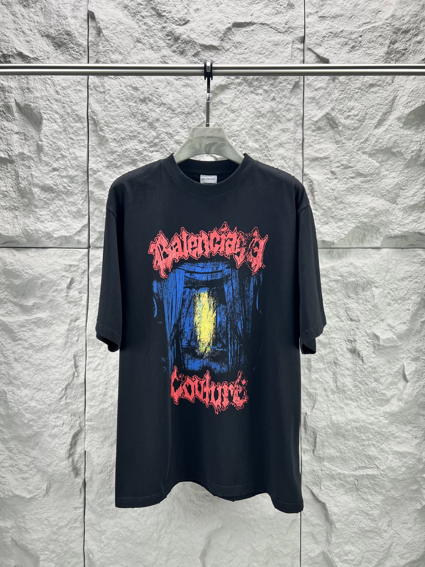 Balenciaga BALENCI*GA salon de couture艺术作品印花短袖本品采用重磅纯棉平纹面料 经预缩水处理后手感厚实挺括 亲肤透气且不易变形 适配日常高频穿着 印花部分采用直喷+胶印叠印工艺先以数码直喷精准还原蓝底黄晕的 做旧肌理 色彩层次丰富且晕染自然 再通过胶印叠加红色哥特字体轮廓 边缘做毛边破碎处理 强化暗黑摇滚视觉张力 同时保障印花牢固度 反复洗涤不易开裂脱落 车线采用双股高弹线 领口 袖口及下摆均做三本针加固 领口内置弹力罗纹并加定型条 有效避免洗后松垮变形 成衣经过酵素洗水做旧处理 整体呈现 做旧质感 风格硬核且穿着舒适 适配街头 摇滚等多元场景 整体走线平直细腻 面料舒适柔软 颜色一致无色差 能与同款搭配营造 造型 驾驭各种场合 定制辅料 三标齐全