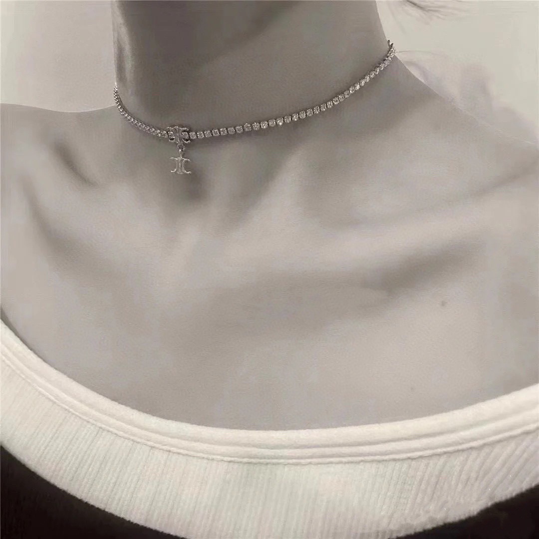Celine Triomphe necklace silver-toned metal with clear cubic zirconia gold-toned Triomphe charm 38cm