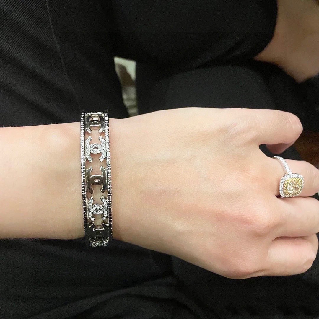 Chanel CC Logo Cutout Crystal Cuff bracelet silver-toned metal with clear crystal accents 17cm inner circumference
