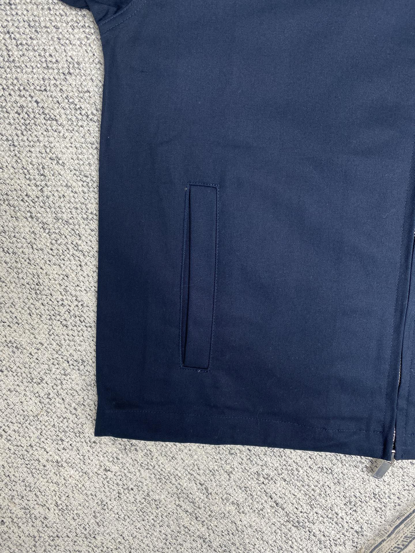  迪奥        25ss新款短夹克采用海军蓝色棉质斜纹布精心制作，经典款式展现休闲风范。底边搭配抽