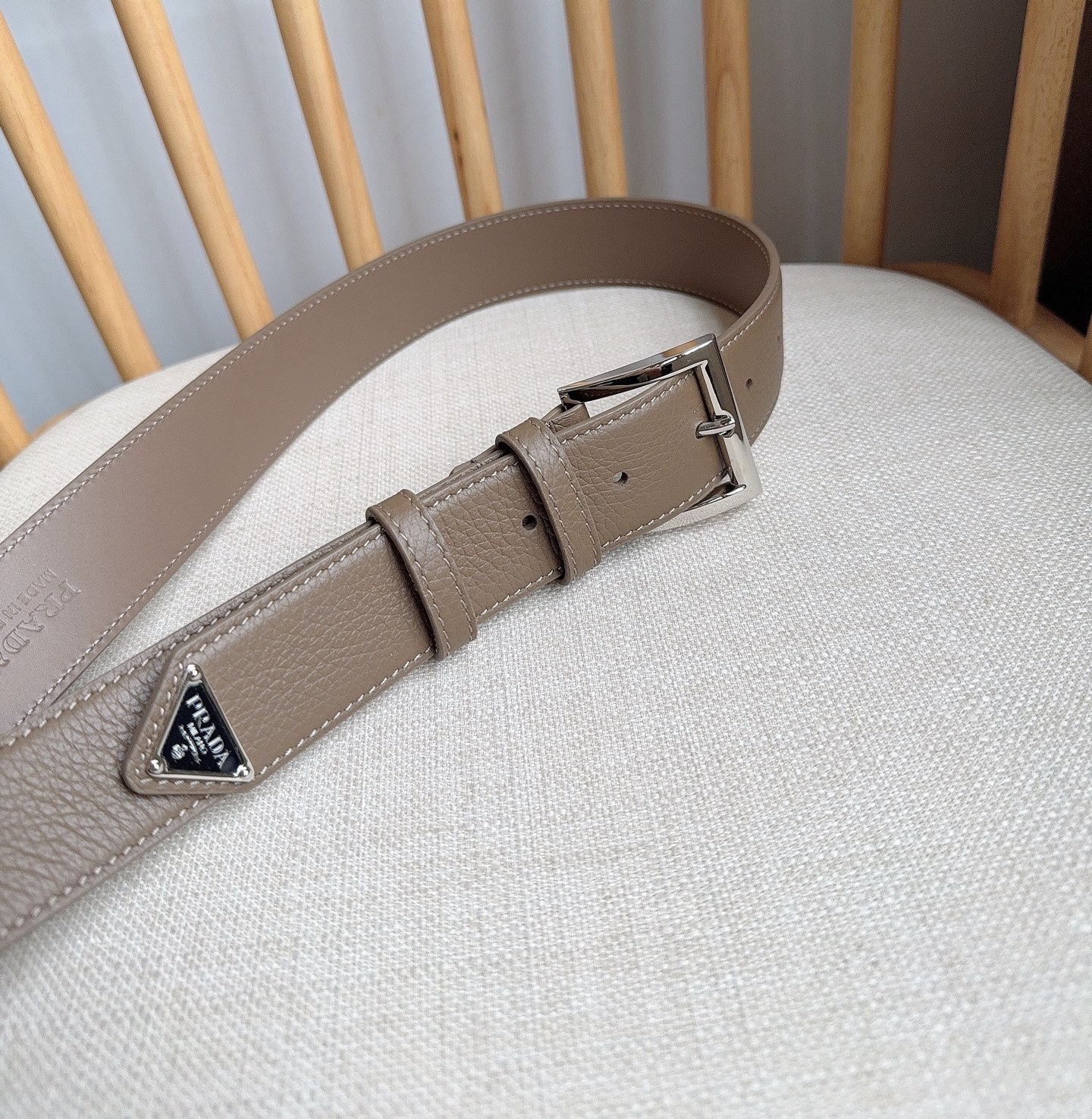PRADA (普拉达) 专柜最新款 这款皮革腰带的尖部饰以标志性的涂珐琅金属三角形徽标 此徽标由Mari