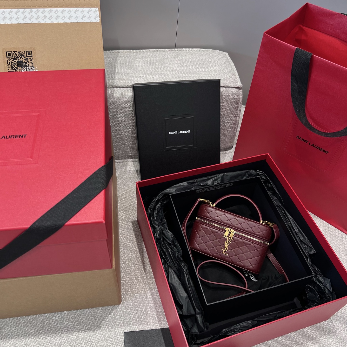 Gaby Vanit Bag in Cabernet Sauvignon red, made of fine lambskin with a wrap-around zipper design. It is delicate and compact, yet spacious enough for daily essentials. Comes with adjustable and detachable leather shoulder strap and handle for versatile use. Size: 18x11x6.5cm. Shoulder strap height: 52cm. Comes with full set of official packaging from the brand. image 1