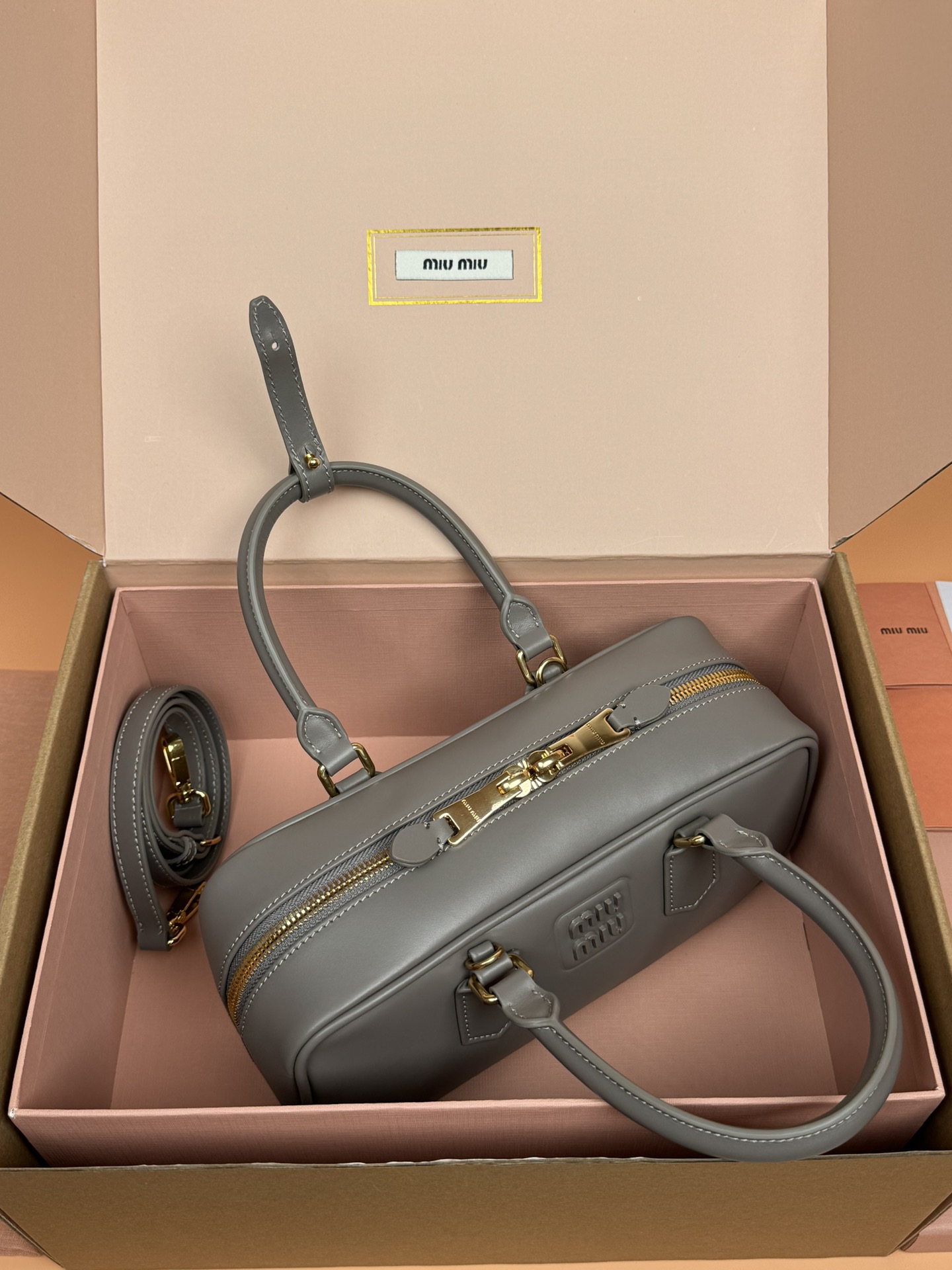 p800。【特级五金原厂皮】Arcadie 牛皮革中号(27cm)保龄球手提包/斜挎包～泥灰色/亚麻灰

这款Arcadic手袋彰显独特的理念，即时装是对现实的反映转译为物质形态的工具。与金属五金配件的饰面相辉映的字母徽标，精致做工卓尔不凡，彰显极具辨识度的经典格调。动感优雅线条搭配可调式可拆卸肩带，呈现富有现代魅力的实用百搭设计。
尺寸:W27×H12×D9cm
編號：5BB148
